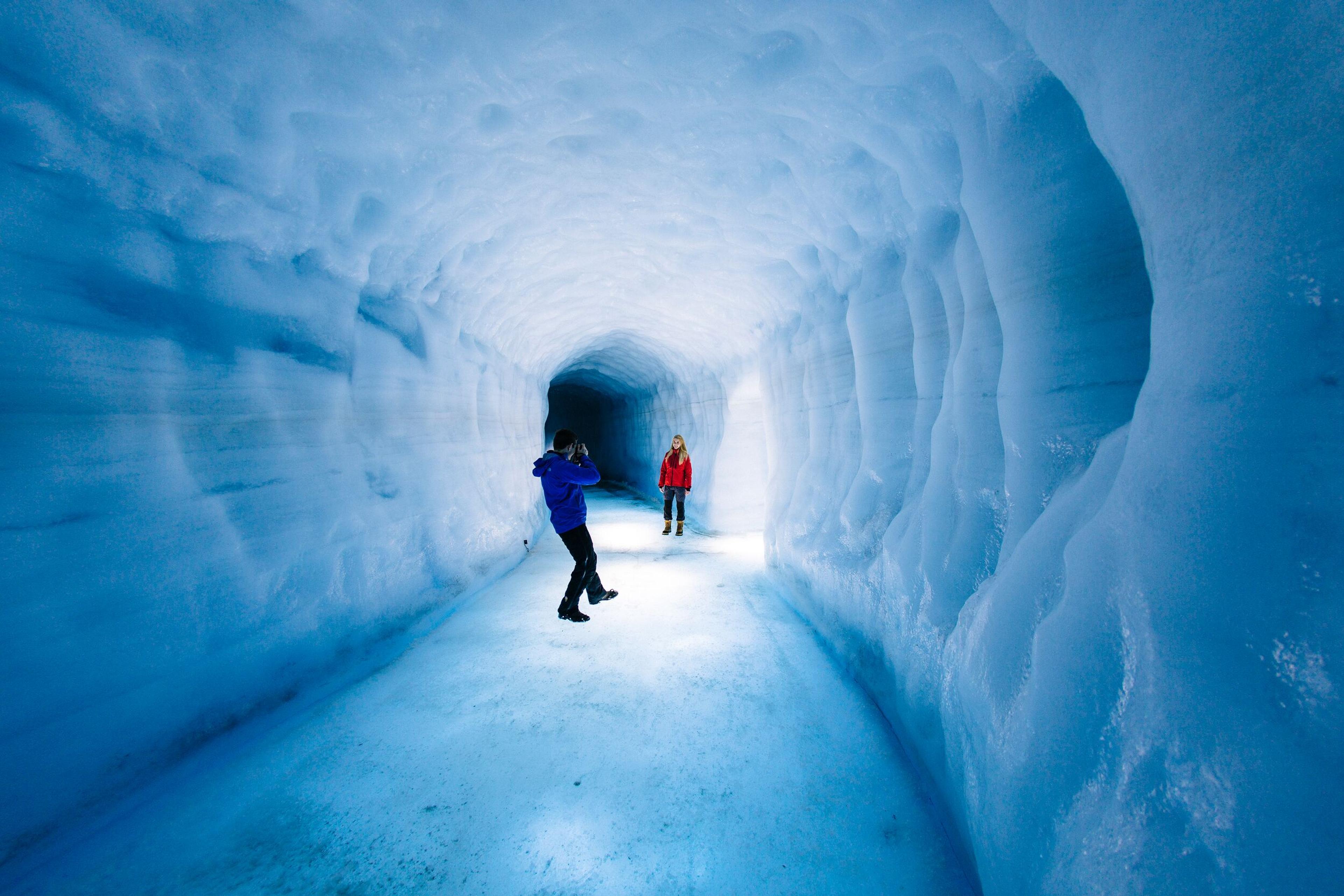 two people inside an ice cave in the Langjökull Glacier in iceland.