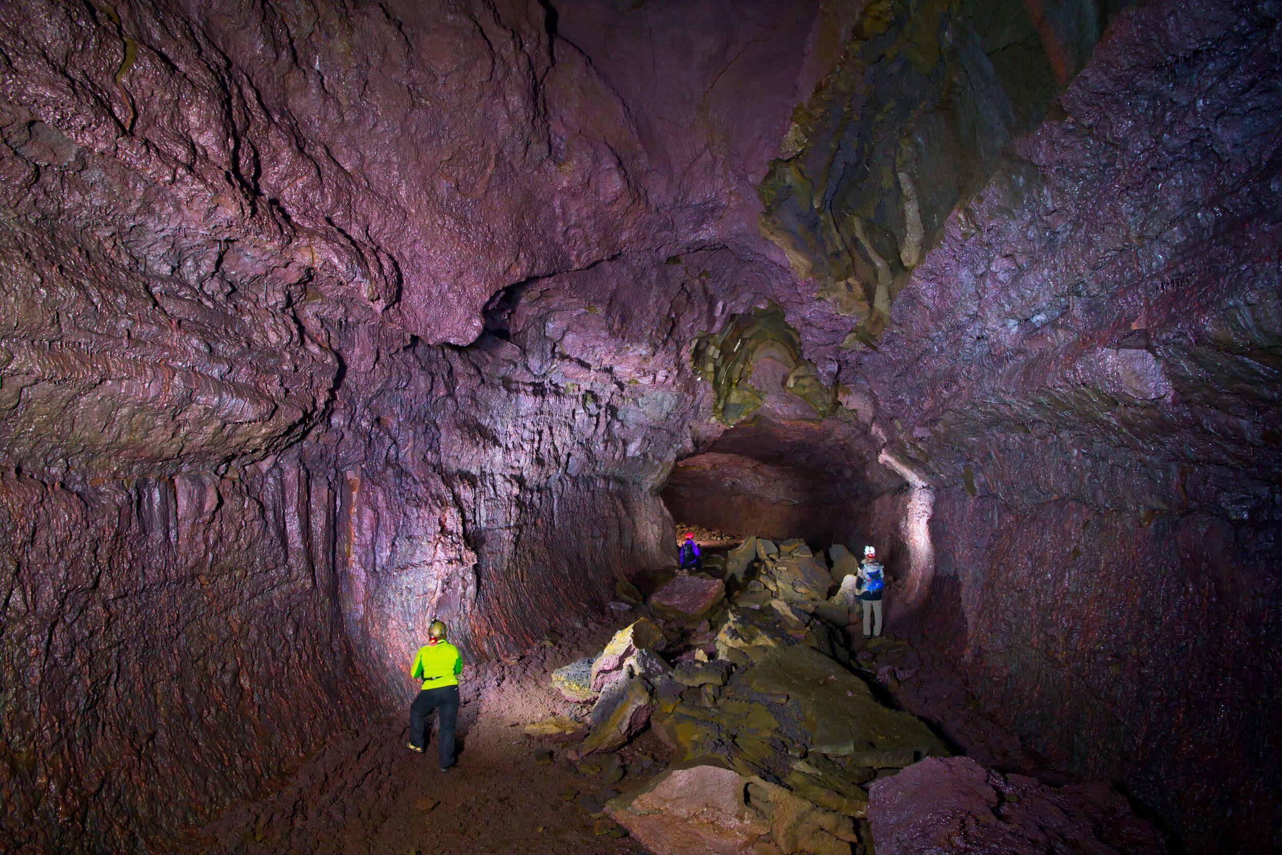 Group of people exlporing the Víðgelmir Lava Cave in Iceland Silver Circle route