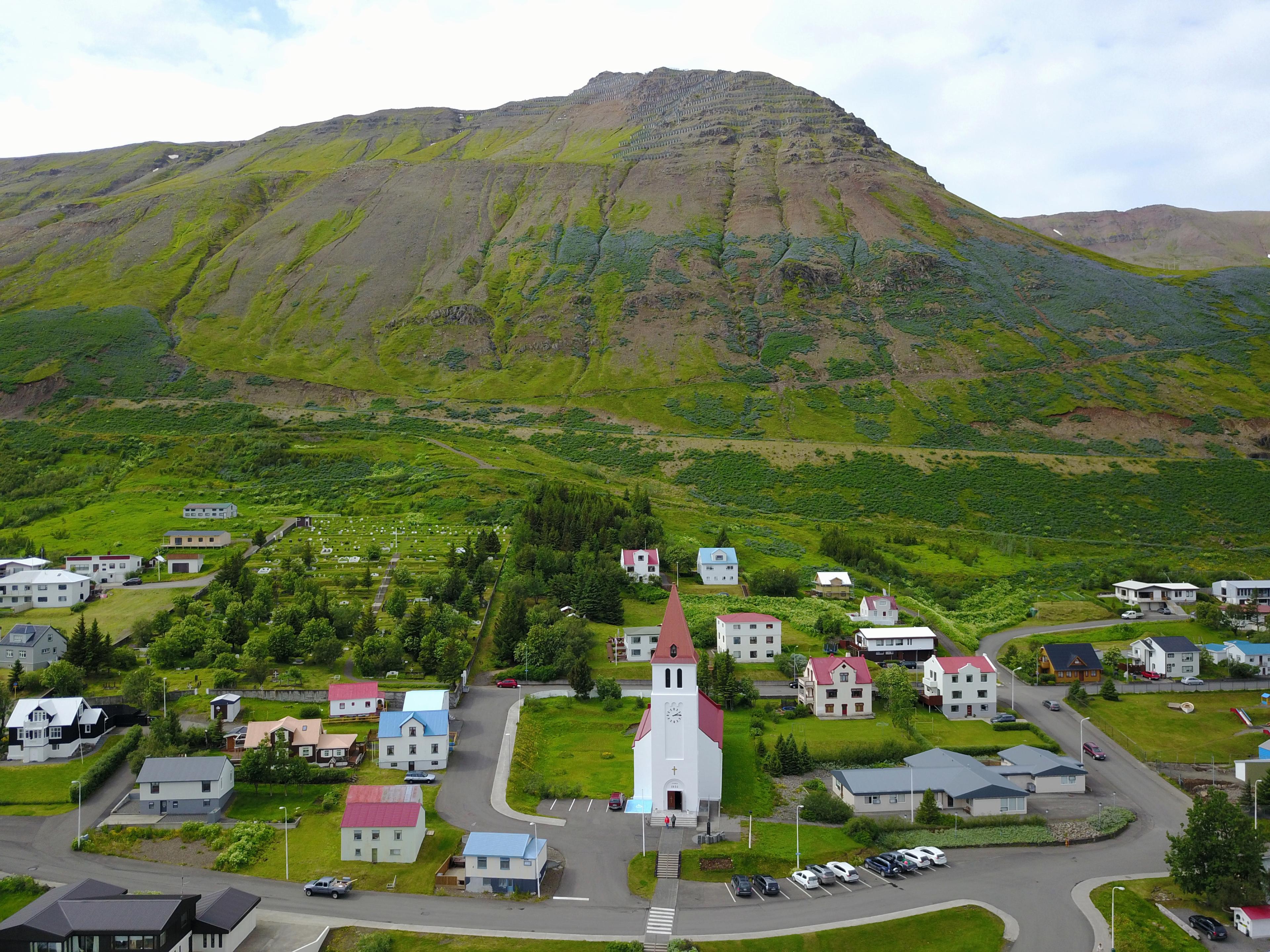 Aerial view of a quaint small town featuring a picturesque church at its center.