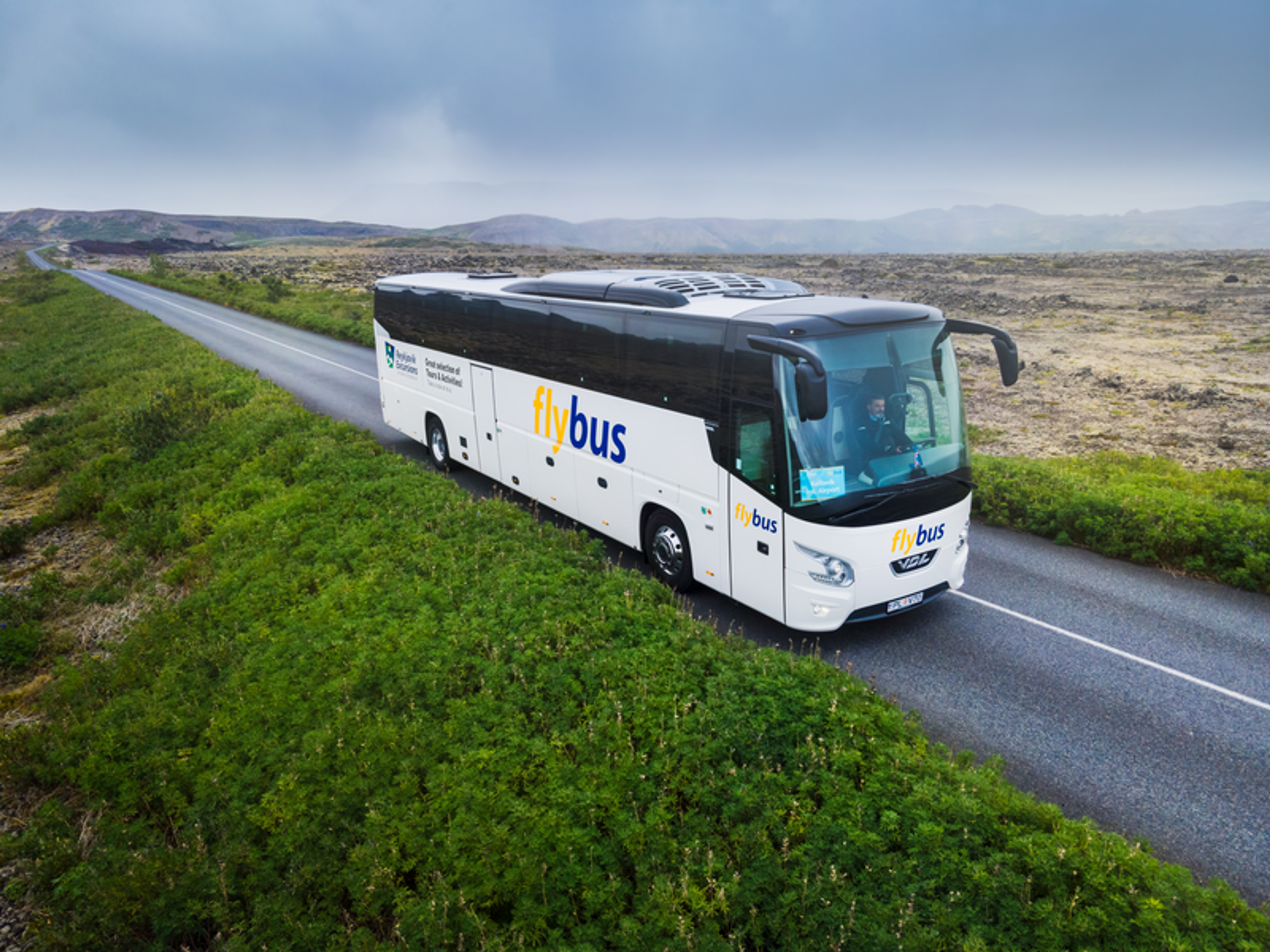 a white bus with the word flybus on the side