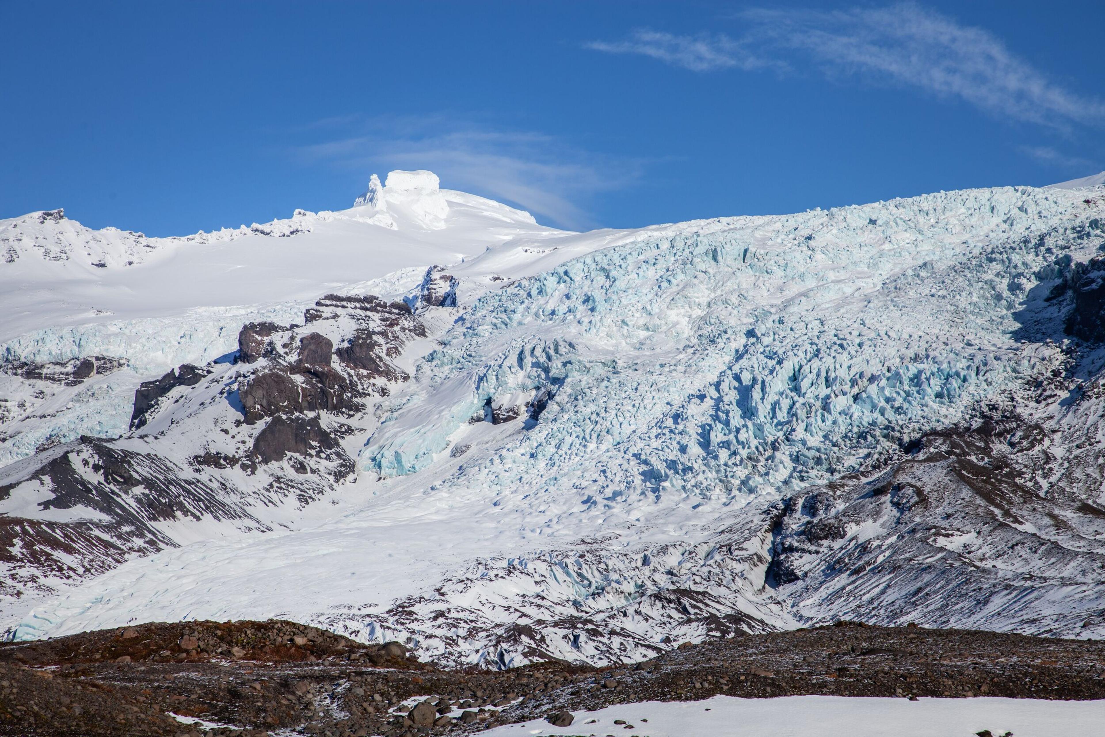 People Walking on Falljökull Glacier, Gazing at the Icefall Ahead
