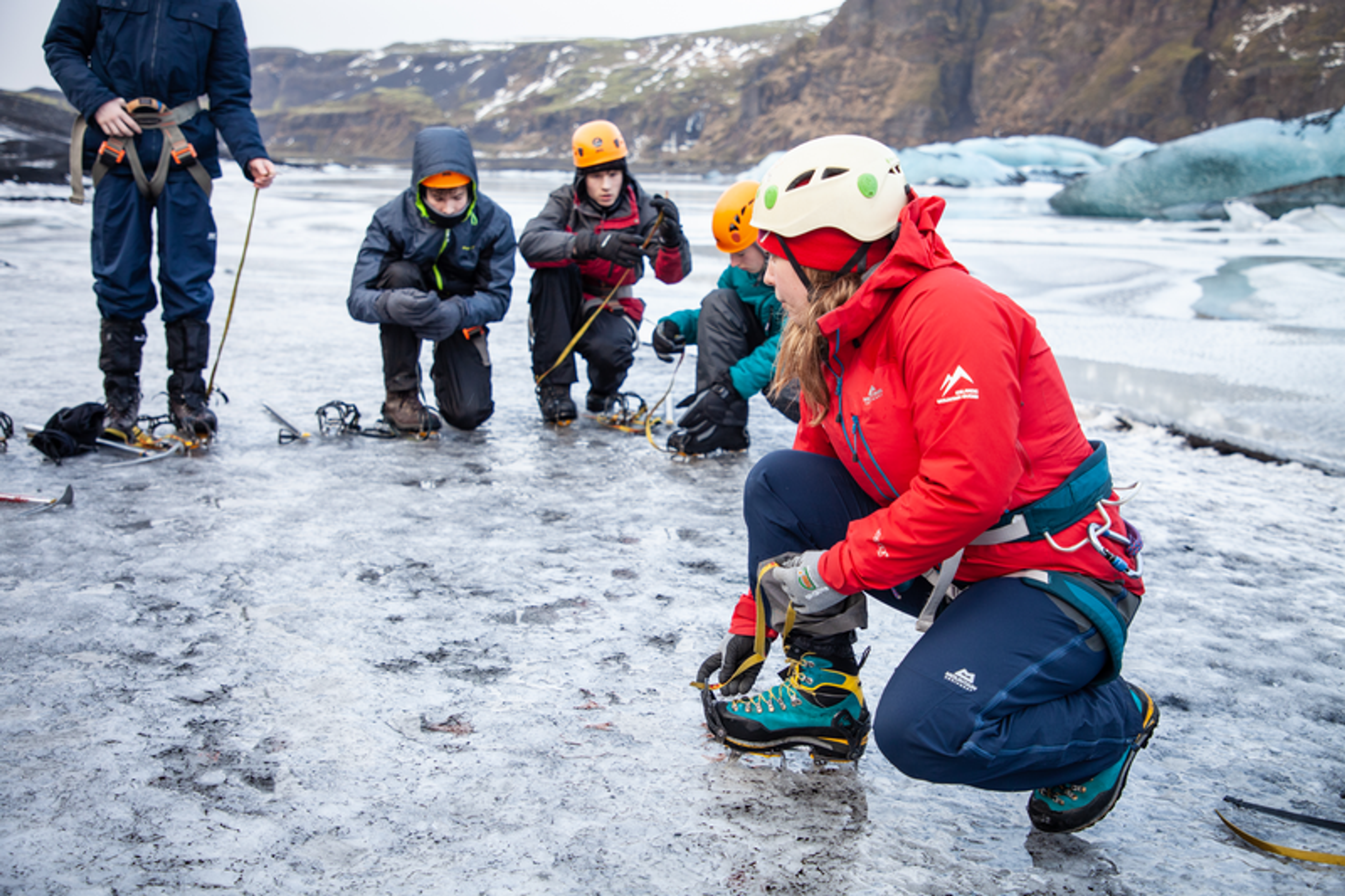 Icelandic Mountain Guide explaining the use of rampons at Sólheimajökull Glacier in the south coast of Iceland