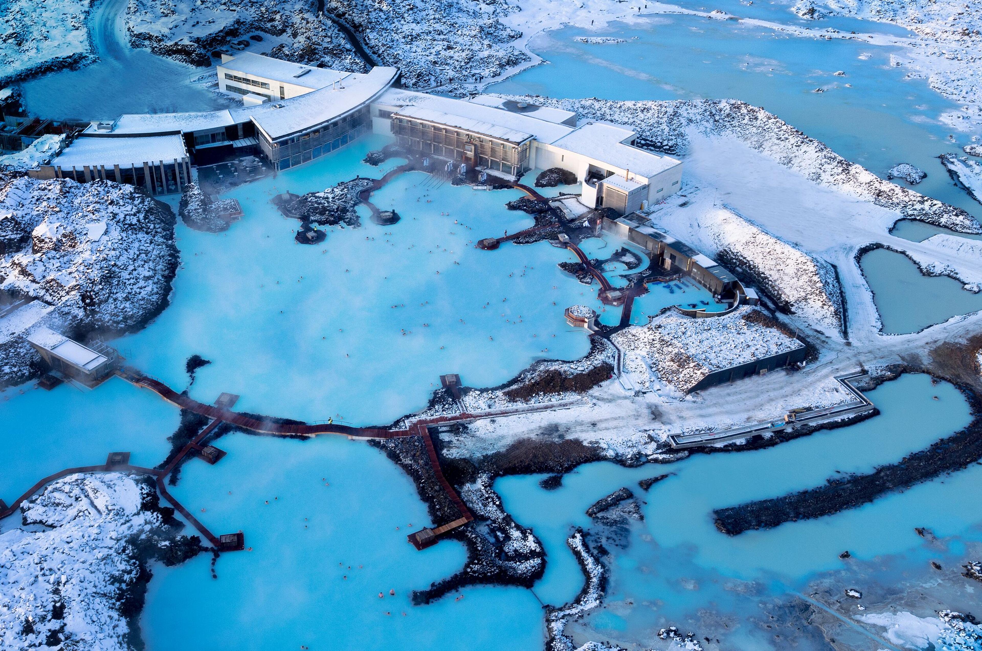 An aerial photo of the Blue Lagoon on a snowy but sunny day.