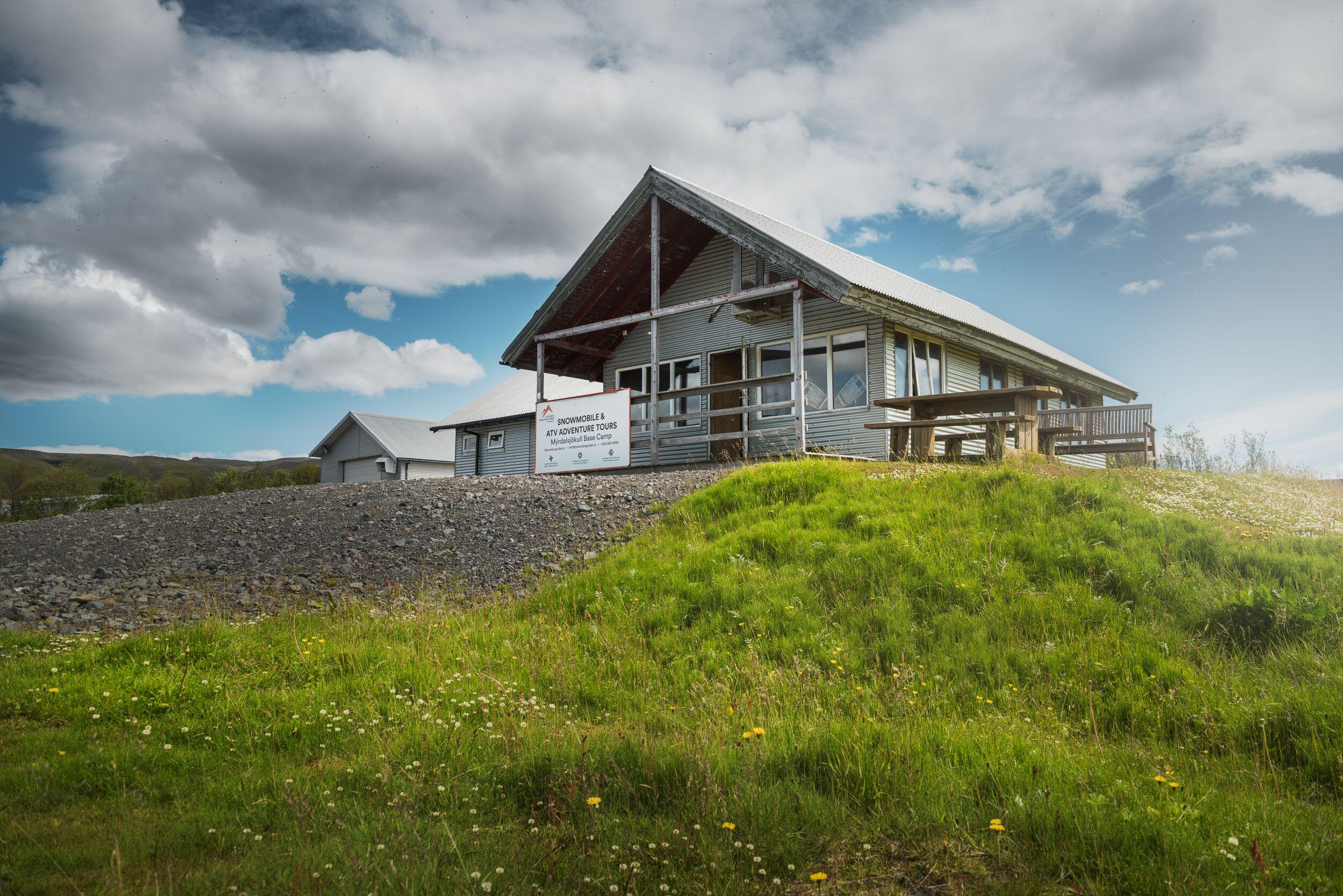 Green Grass, Mýrdalsjökull Base Camp with Yellow Flowers and Blue Sky