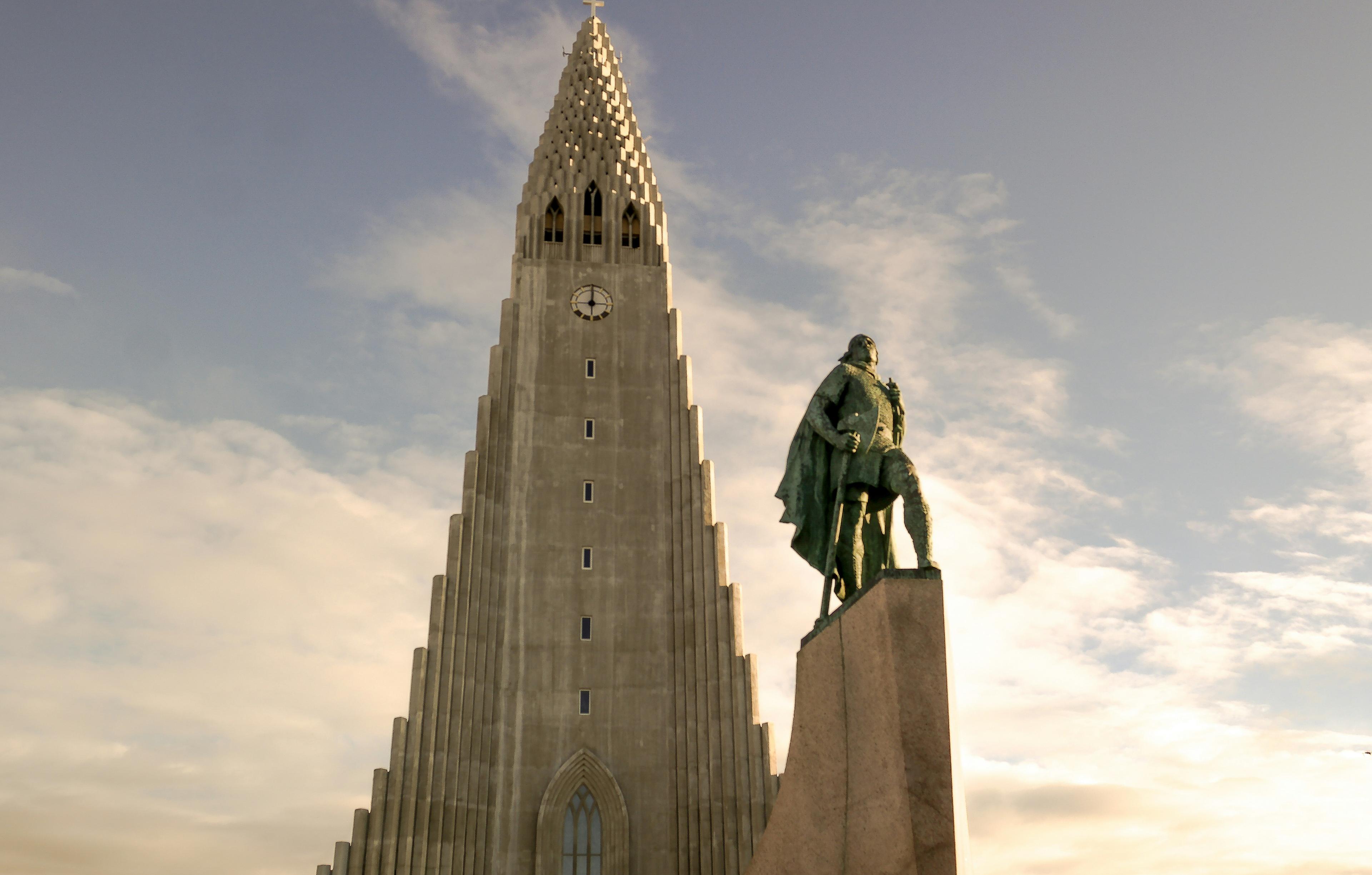 The Hallgrímskirkja church and the Leif Erikson statue against a cloudy sky.