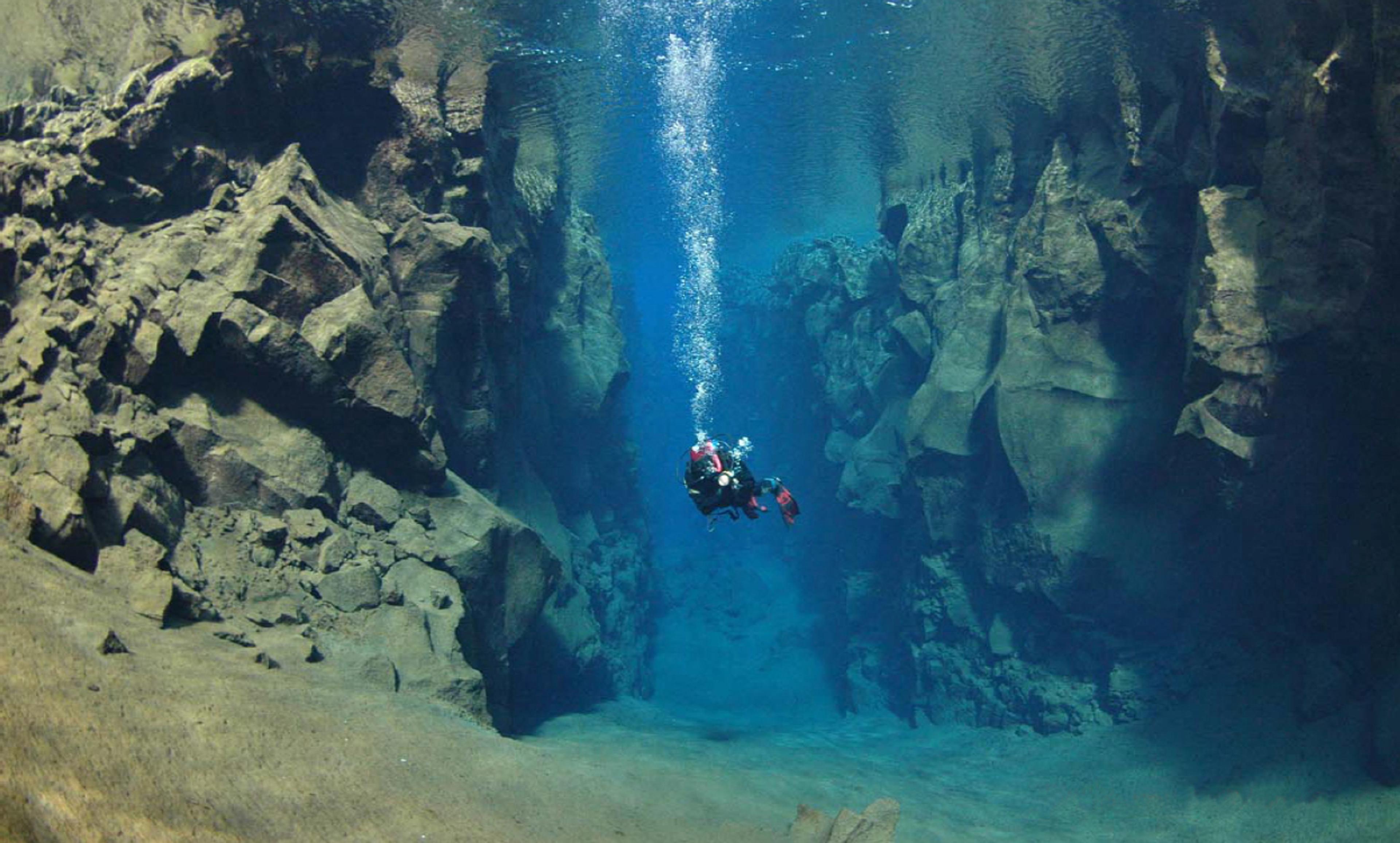 A scuba diver in the majestic  Silfra fissure in Thingvellir National Park