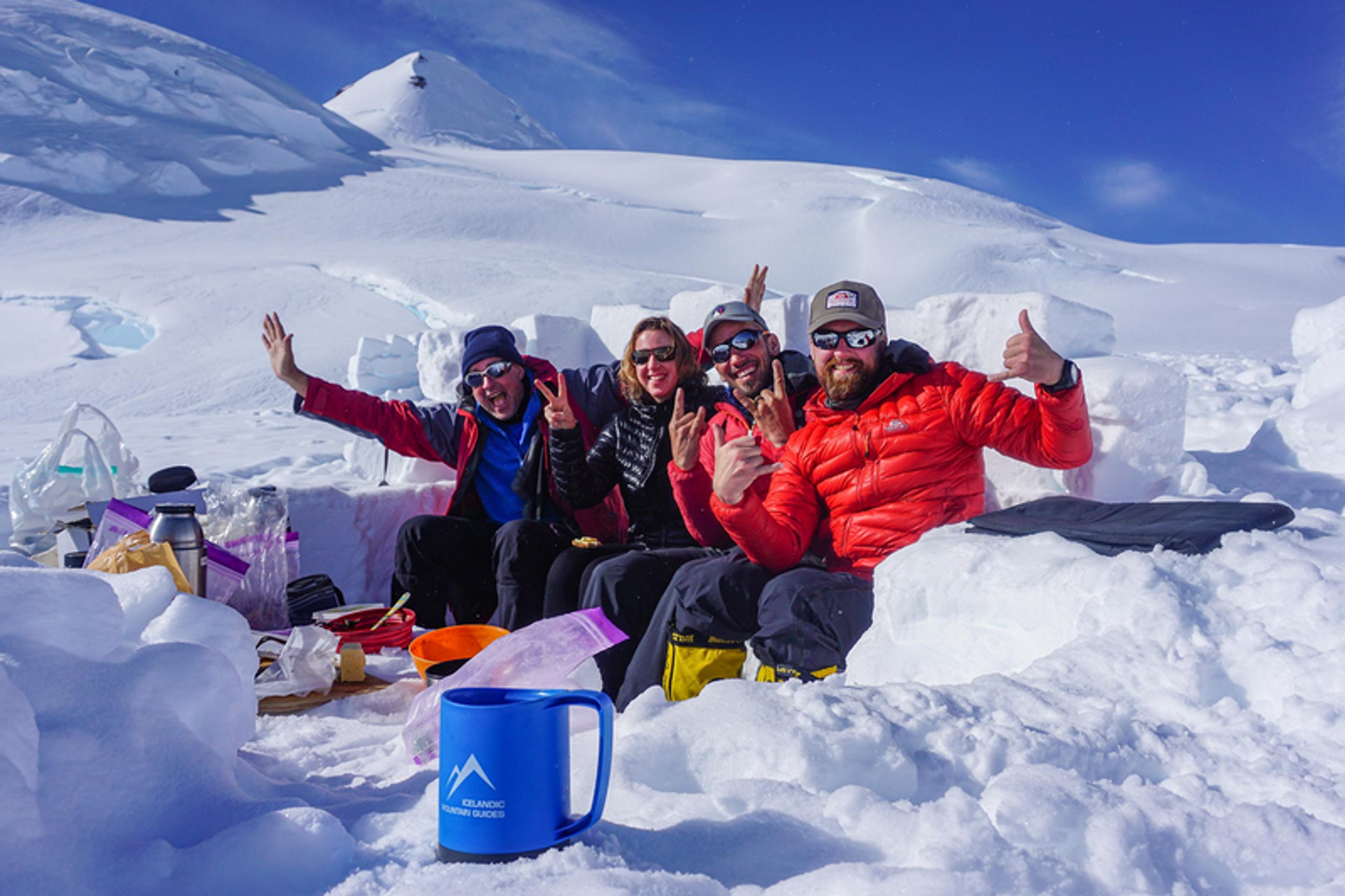 Group of people taking a brake on their way up to Mount Gunnbjörn in Greenland.