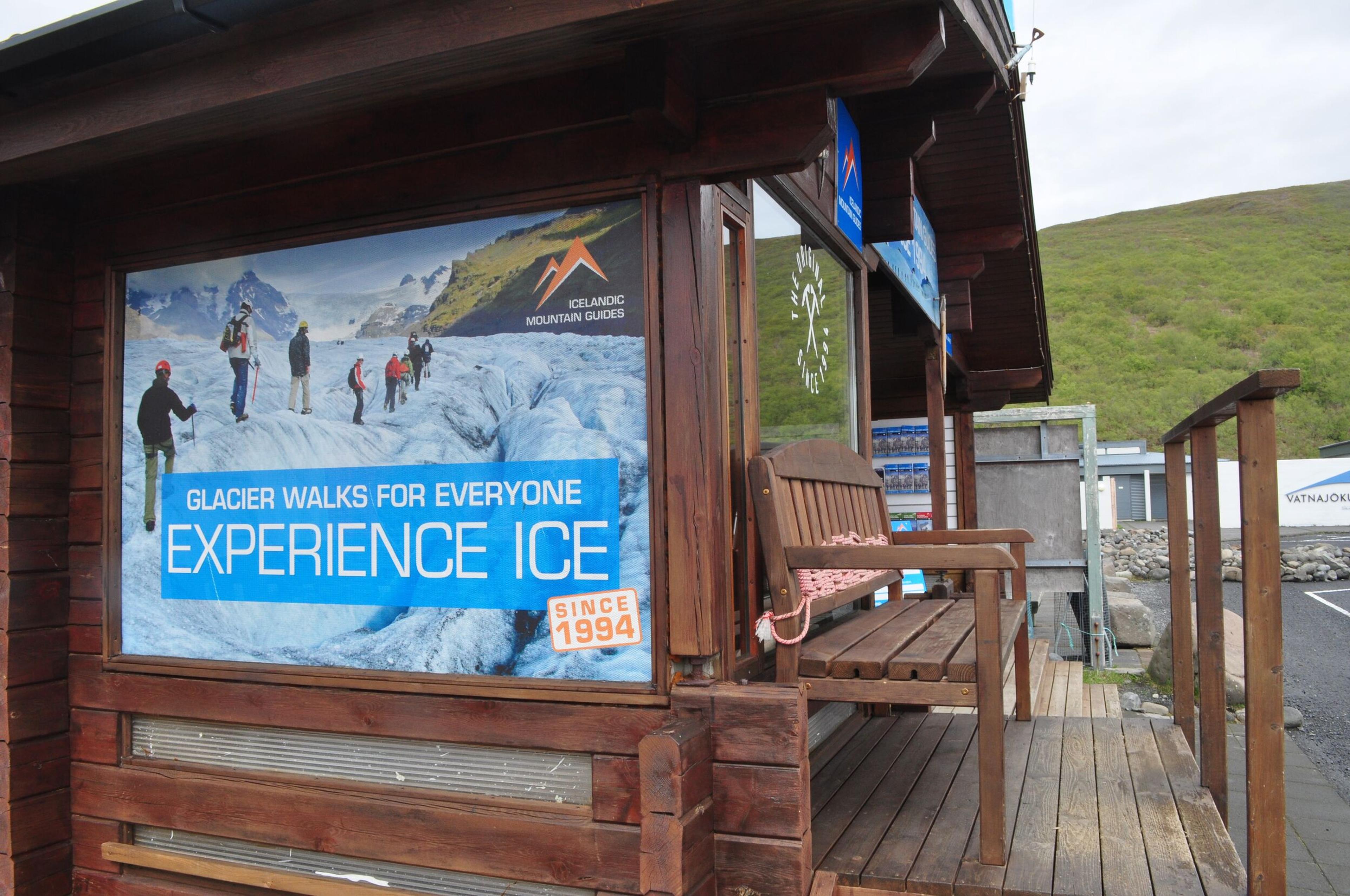 Wooden structure displaying a poster promoting glacier hiking adventures.
