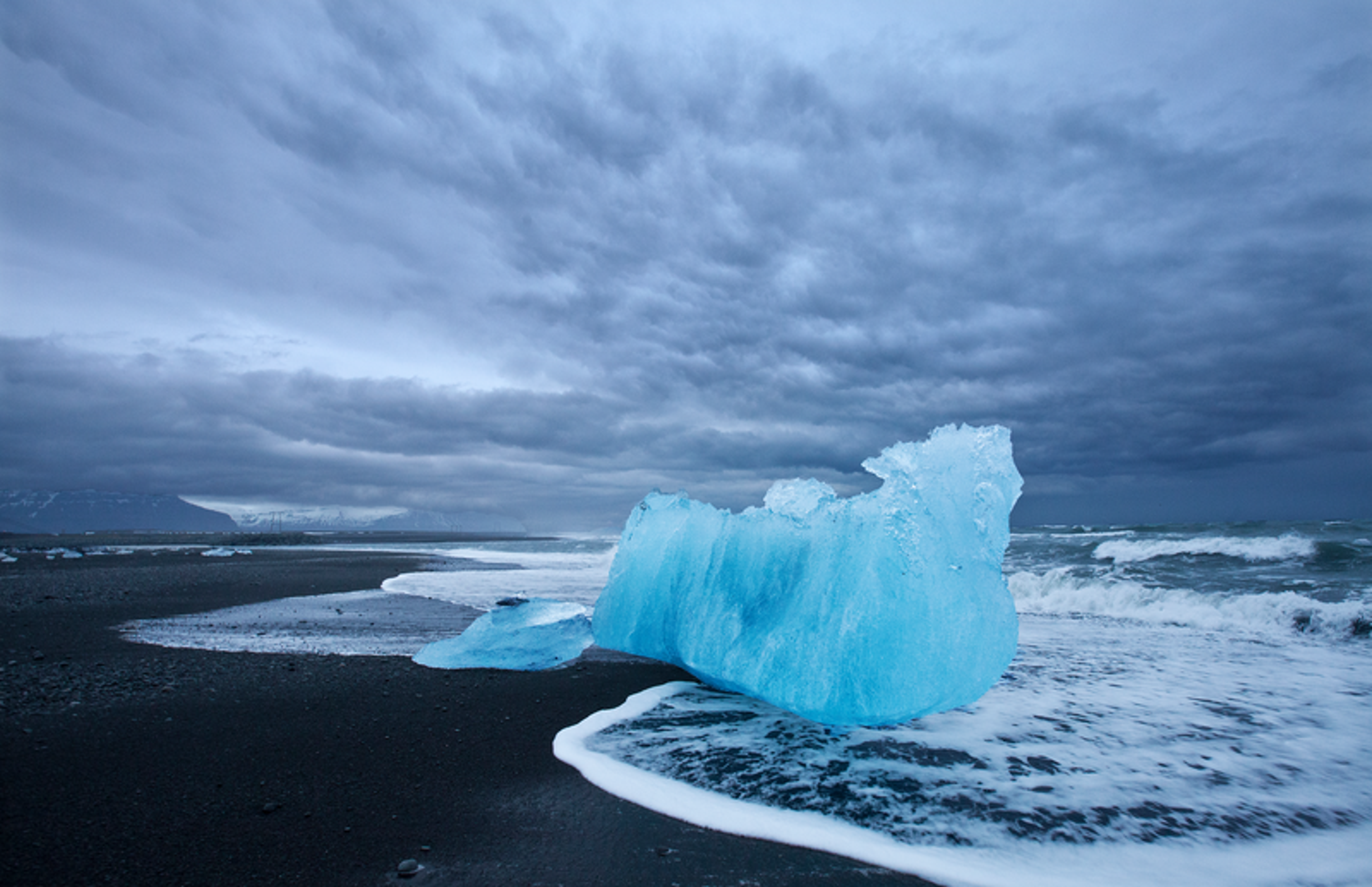 A blue iceberg on diamond's beach shore.