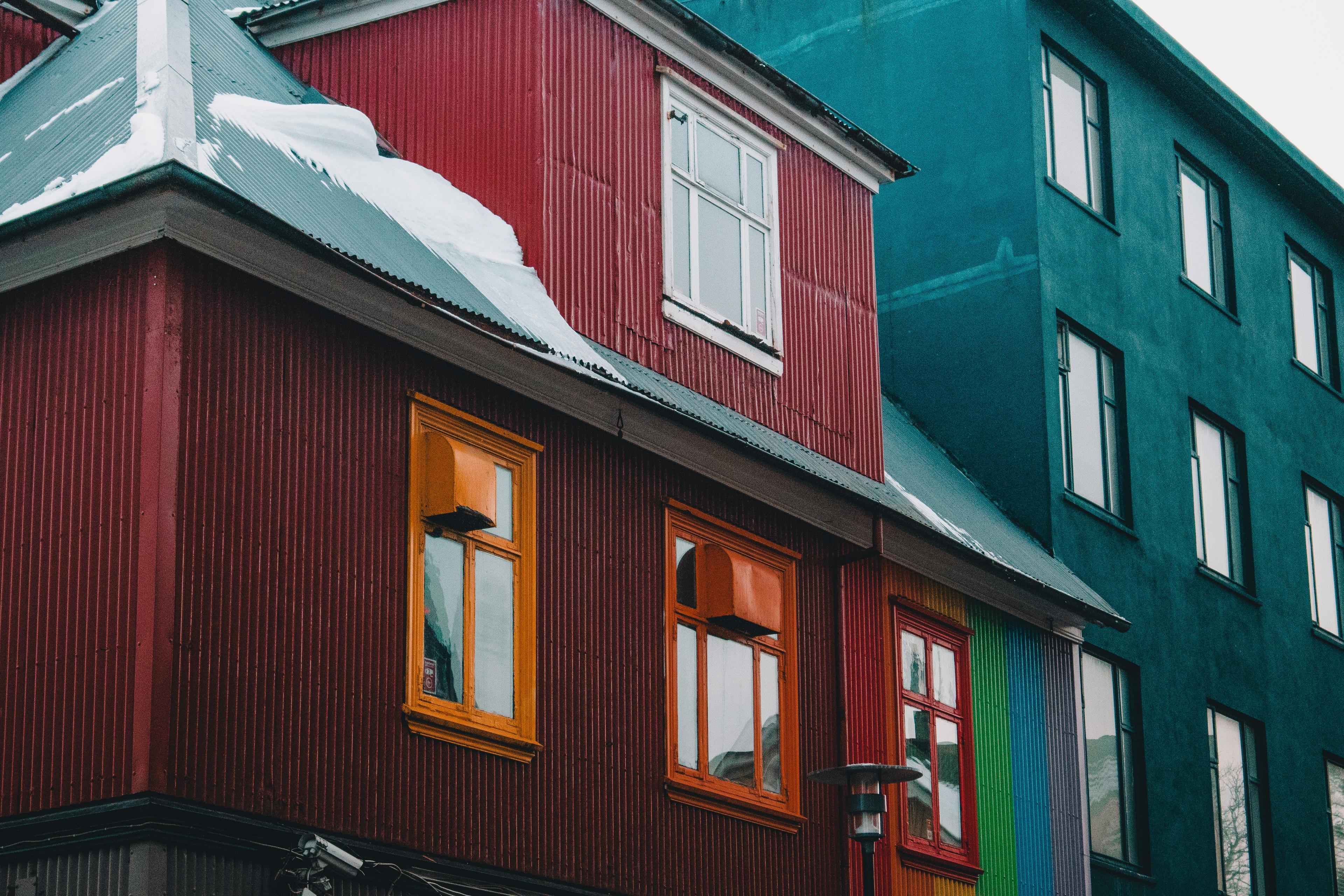 Colorful buildings with snow-covered roofs in Reykjavík, Iceland, showcasing the city's vibrant architecture.