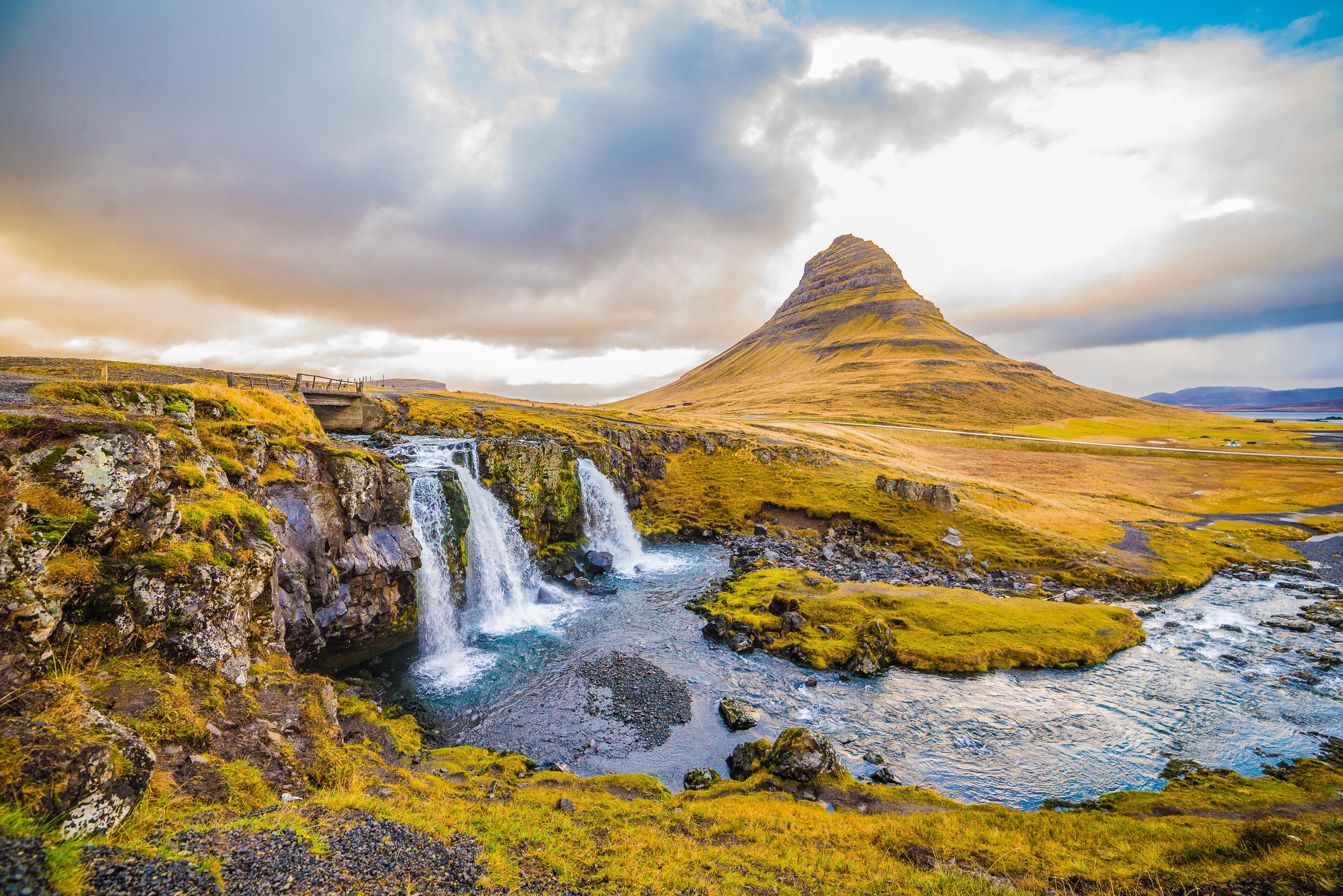 Beautiful blue cascades with the cone-shaped Kirkjufell mountain in the background