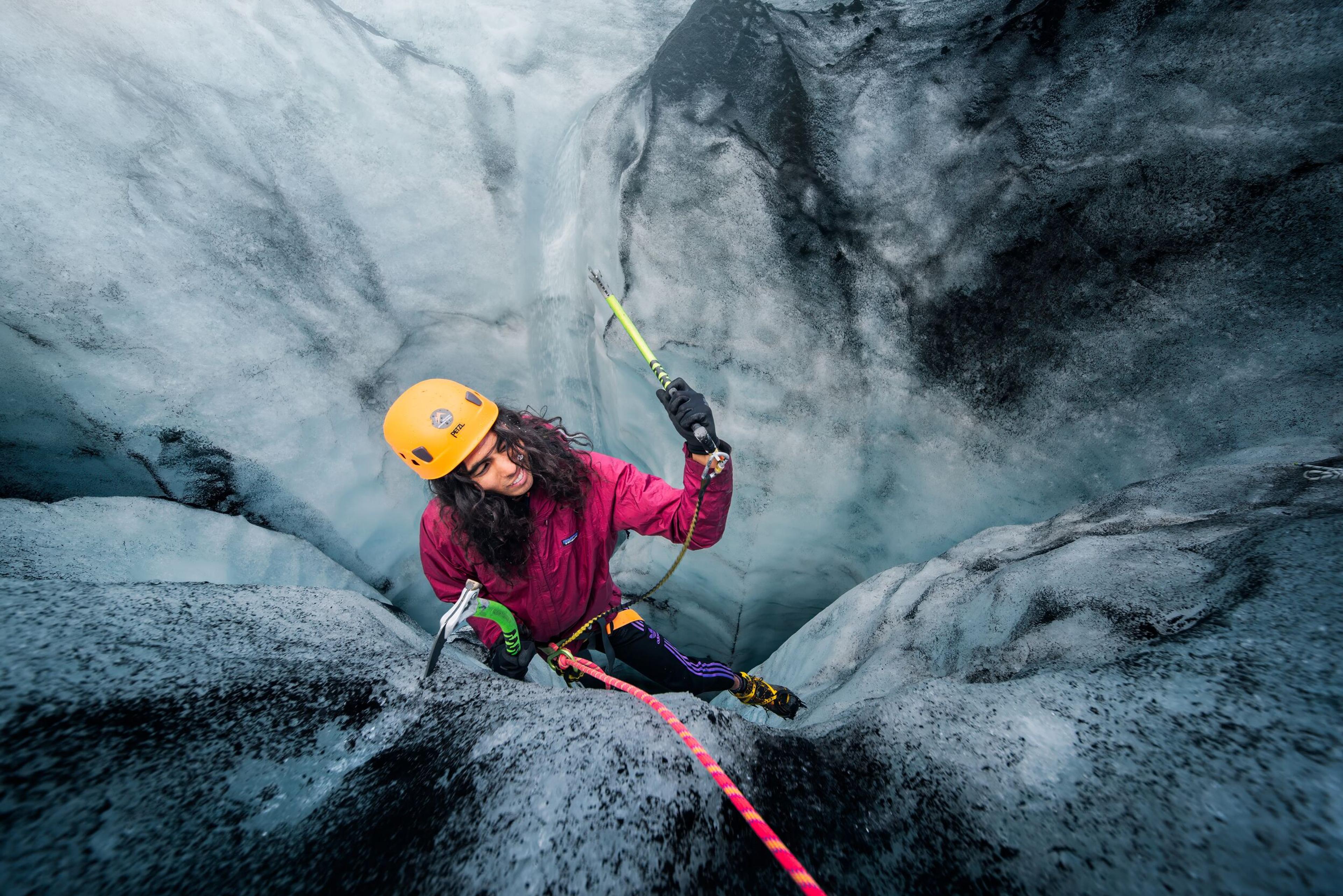 Hikers climbing a glacier wall on the Sólheimajökull Glacier in the south coast of Iceland