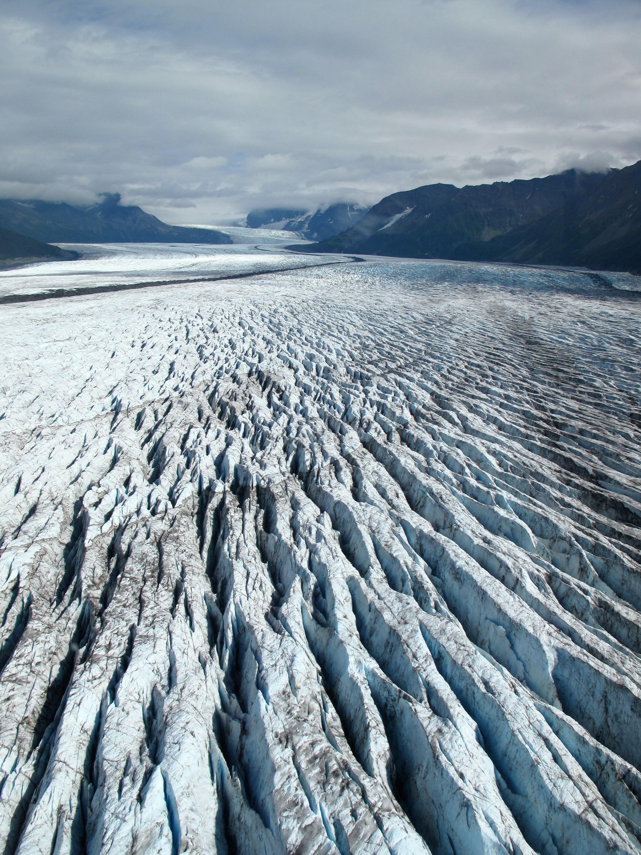 Aerial view of a rugged glacial surface full of deep crevasses
