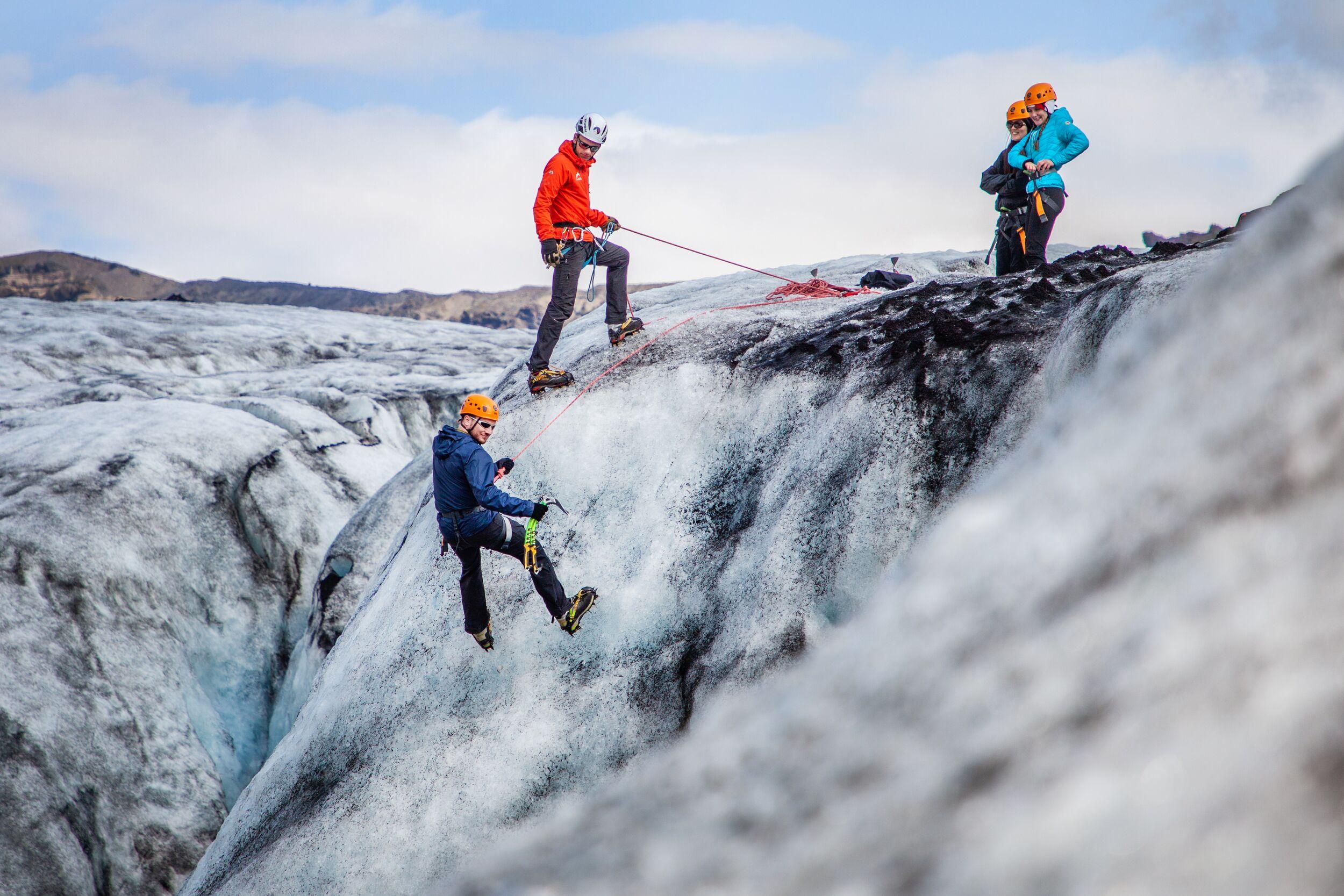 A group of people climbing an ice wall.
