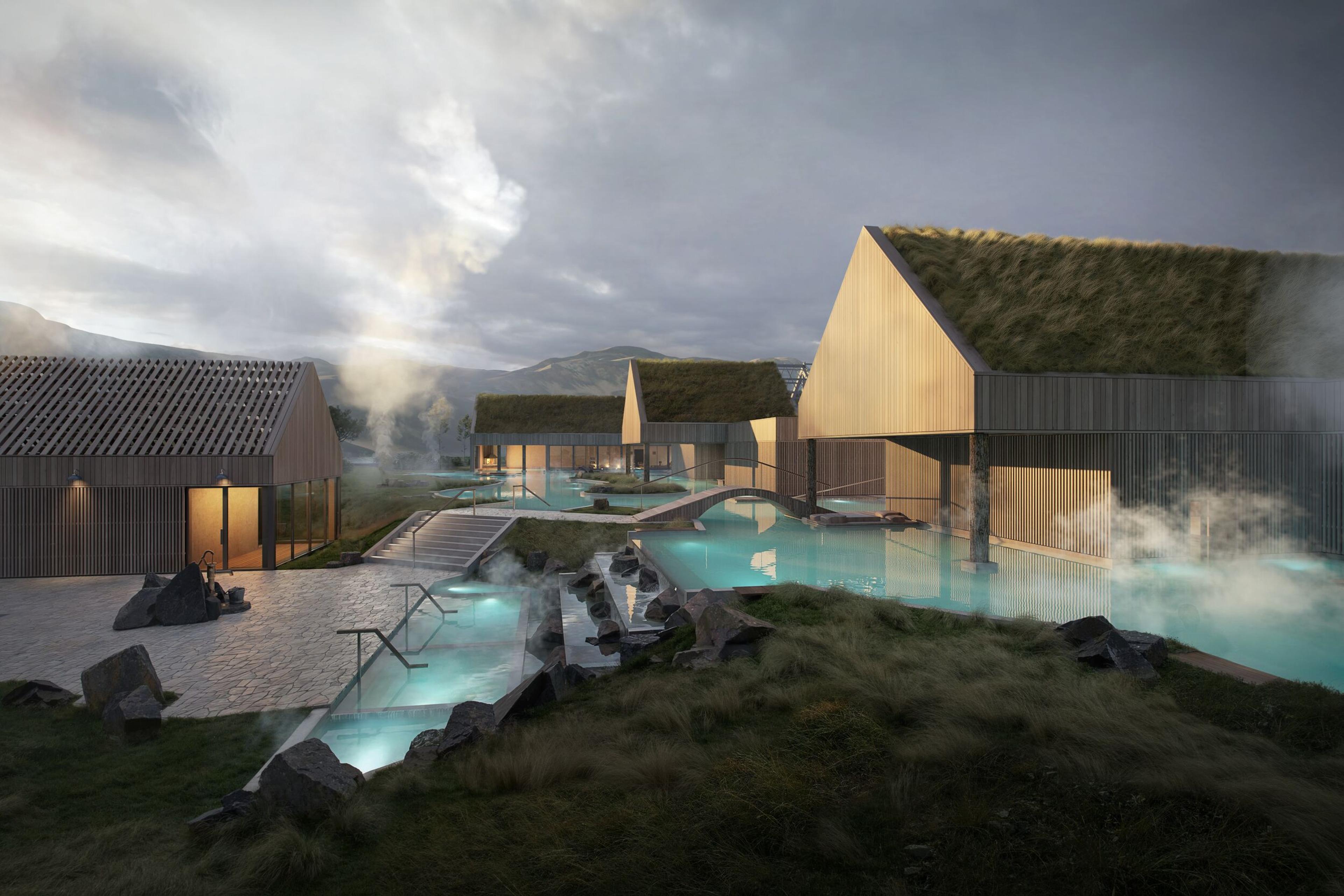 A modern geothermal spa with wooden buildings, grass roofs, and steaming blue pools set against a cloudy mountain landscape.