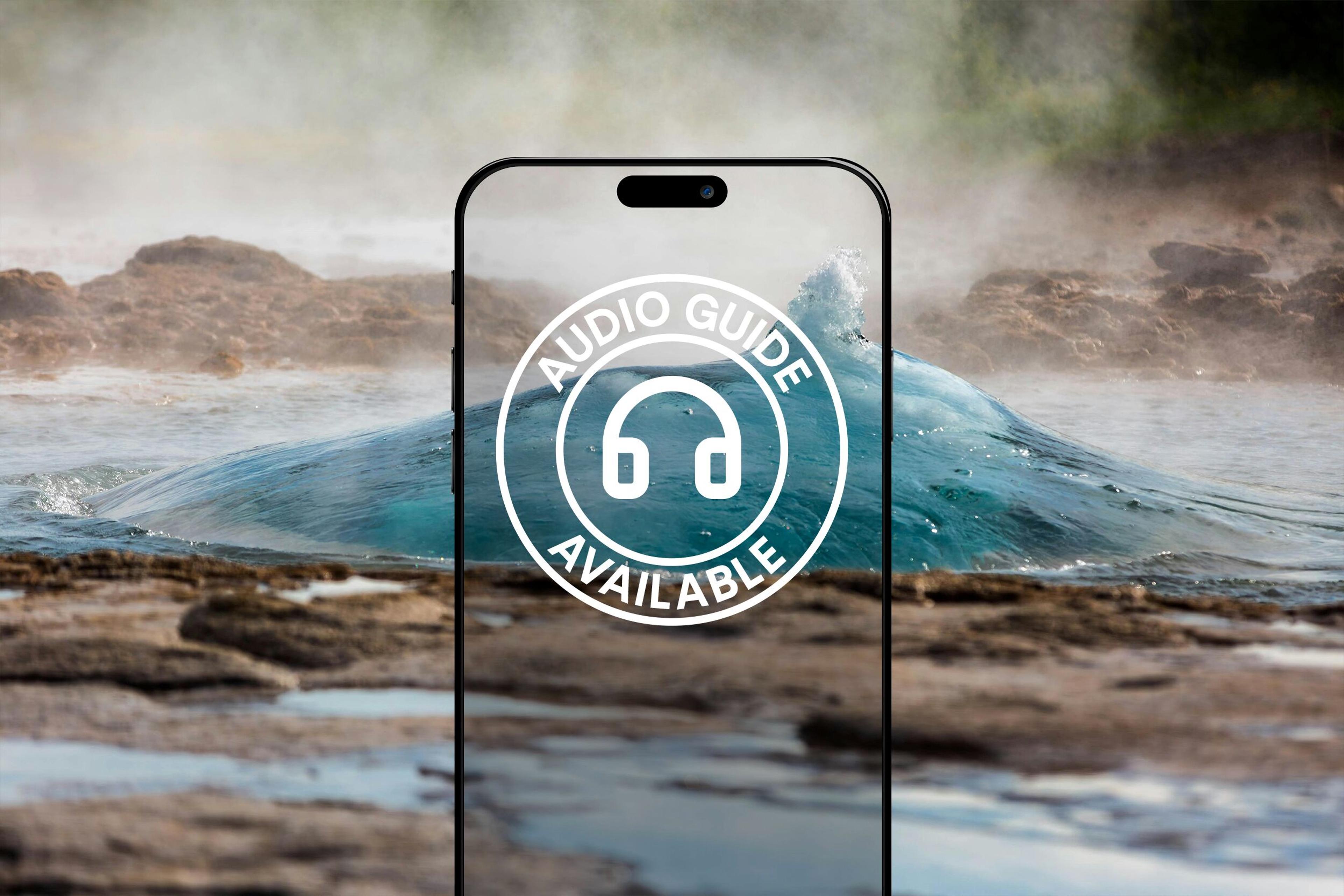 A smartphone outline with an "AUDIO GUIDE AVAILABLE" icon superimposed over a steaming geyser with erupting blue water.