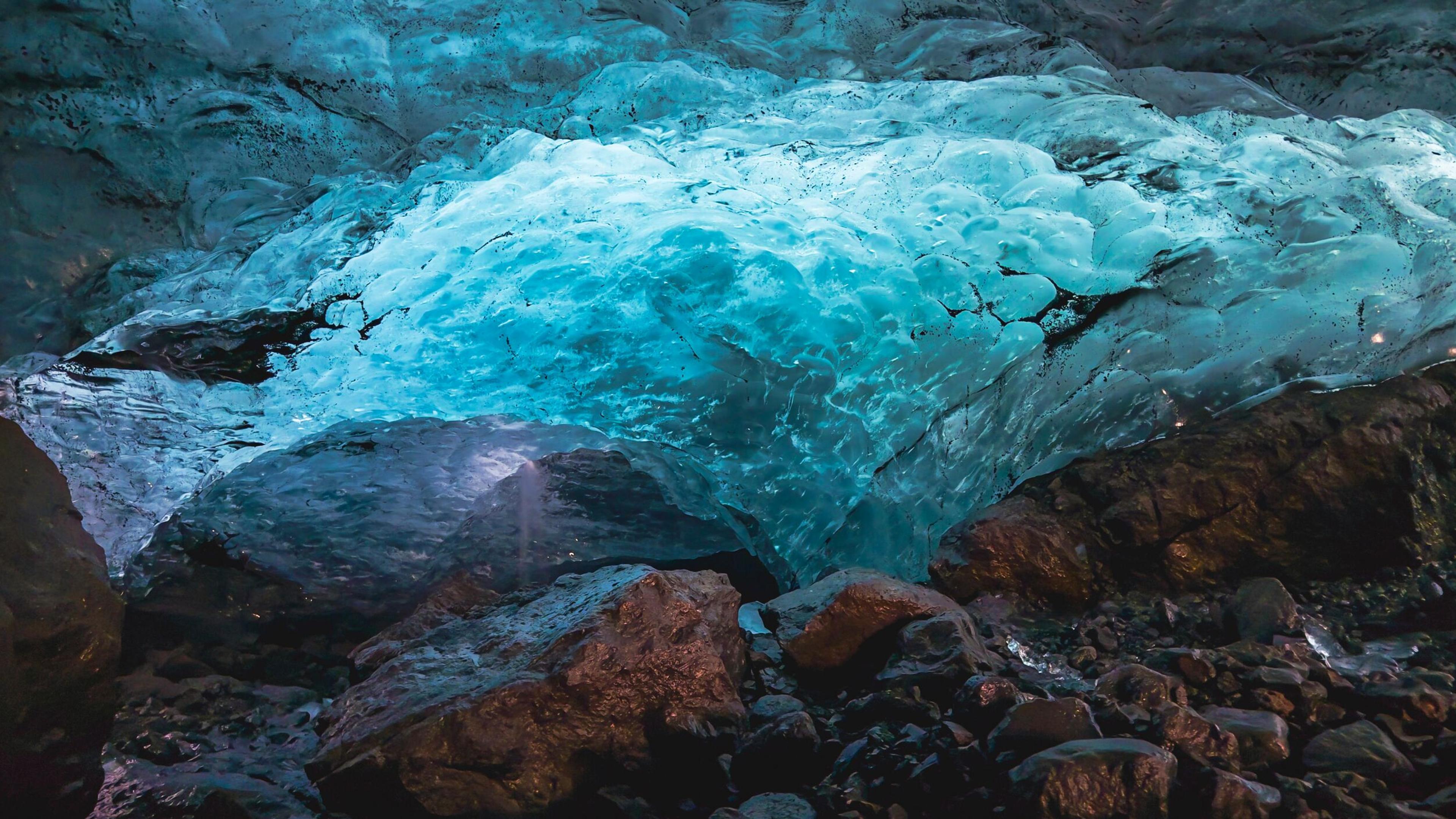 a large piece of ice is sitting on top of a rock in a cave .