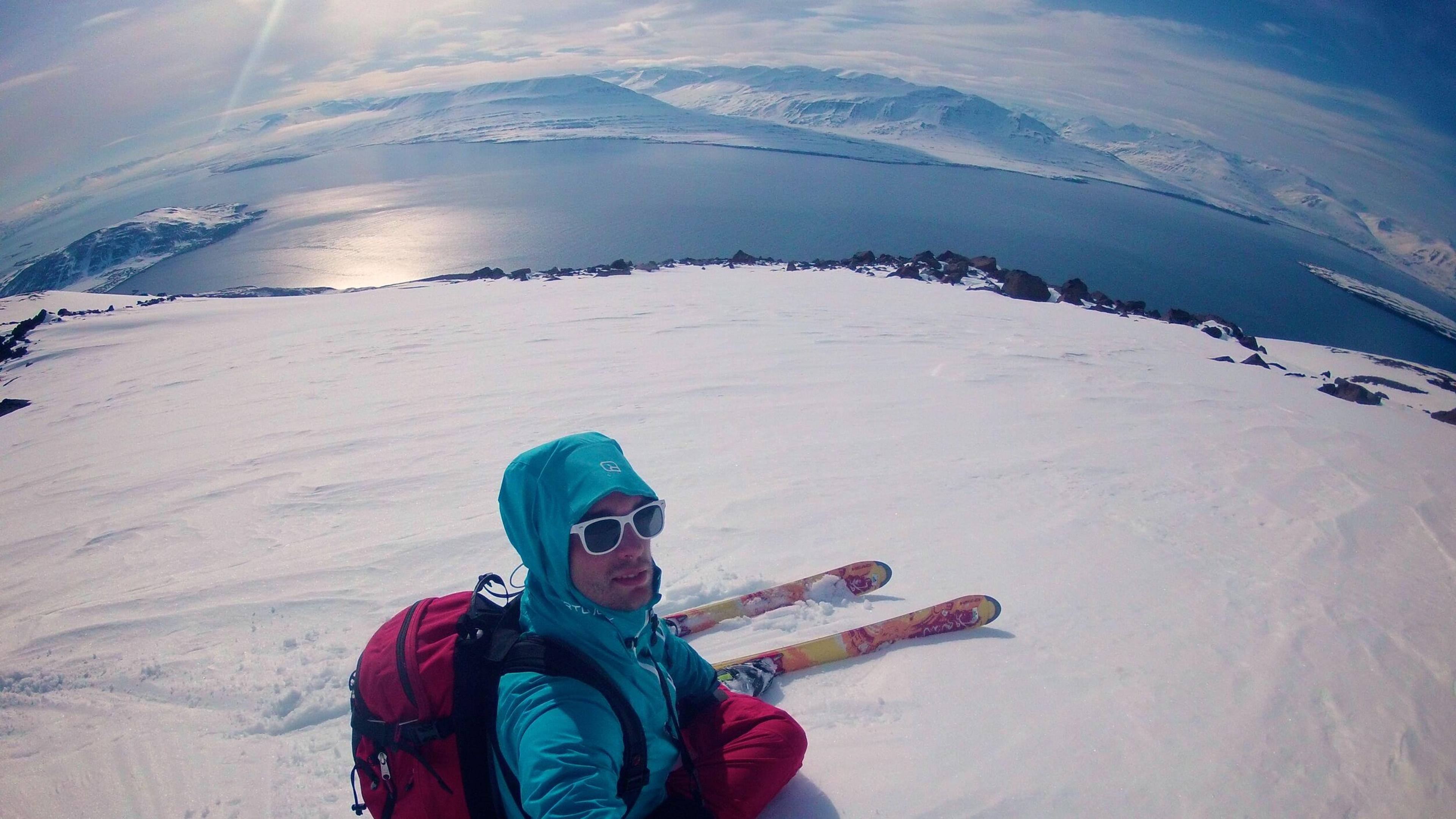 Skier on top of mountain Kaldbakur,  view over Eyjafjörður and Hrísey island.