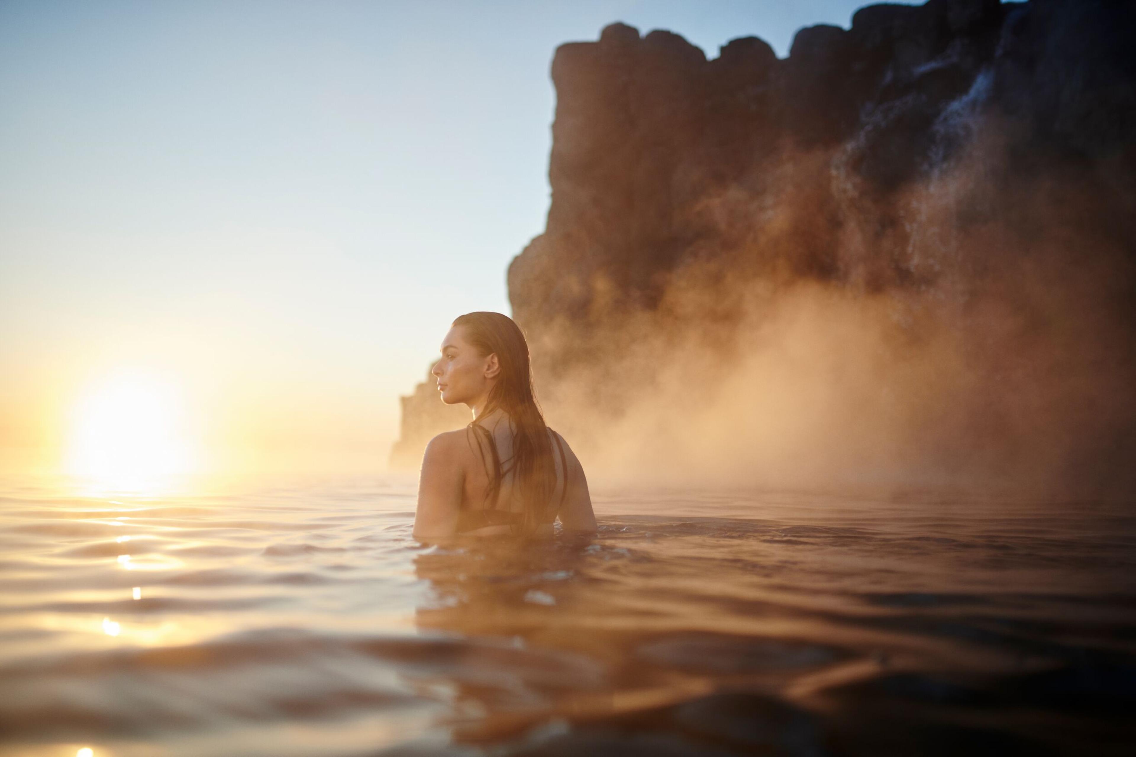Woman soaking in the hot water of Sky lagoon, Iceland.