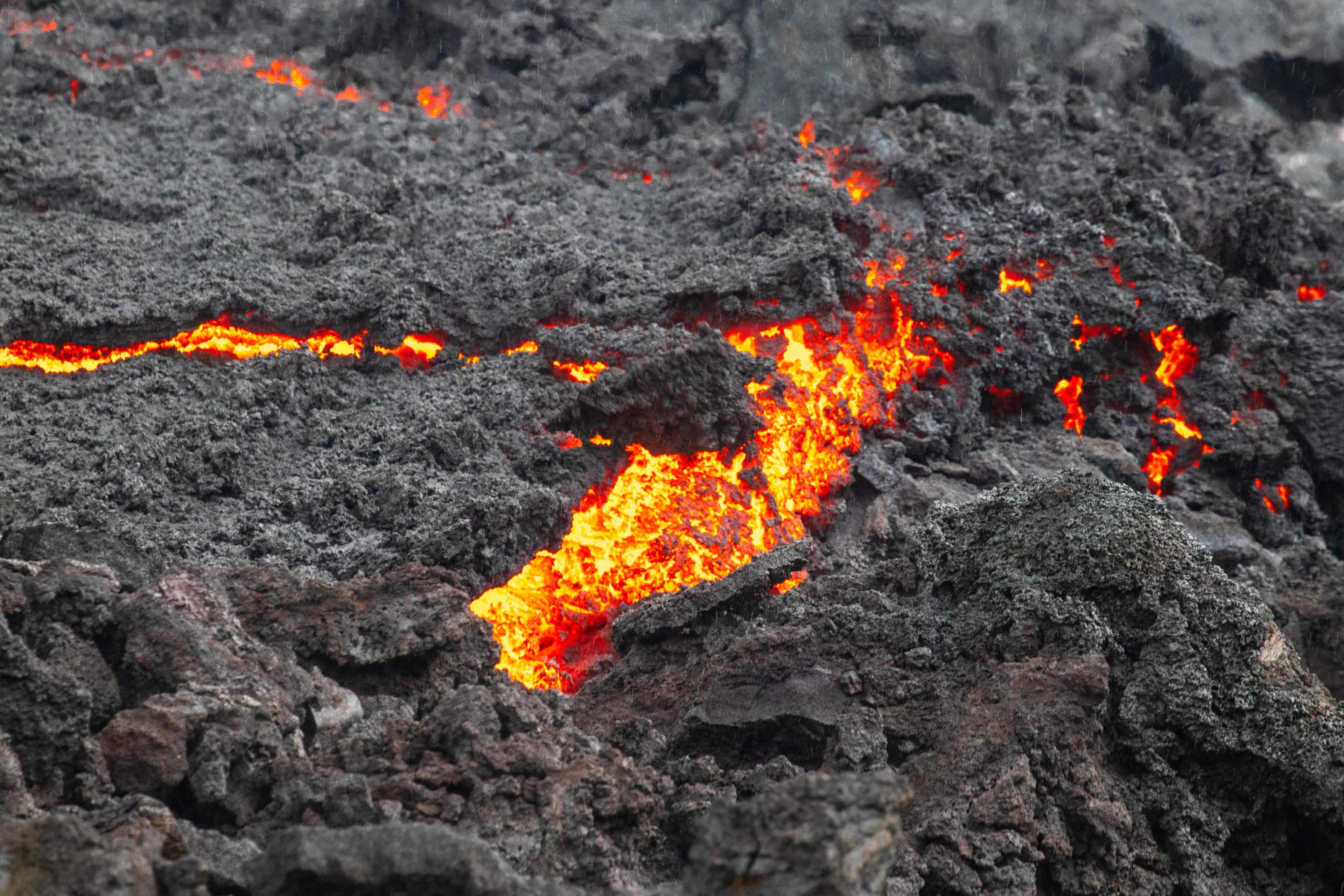 a close up of lava coming out of a volcano .