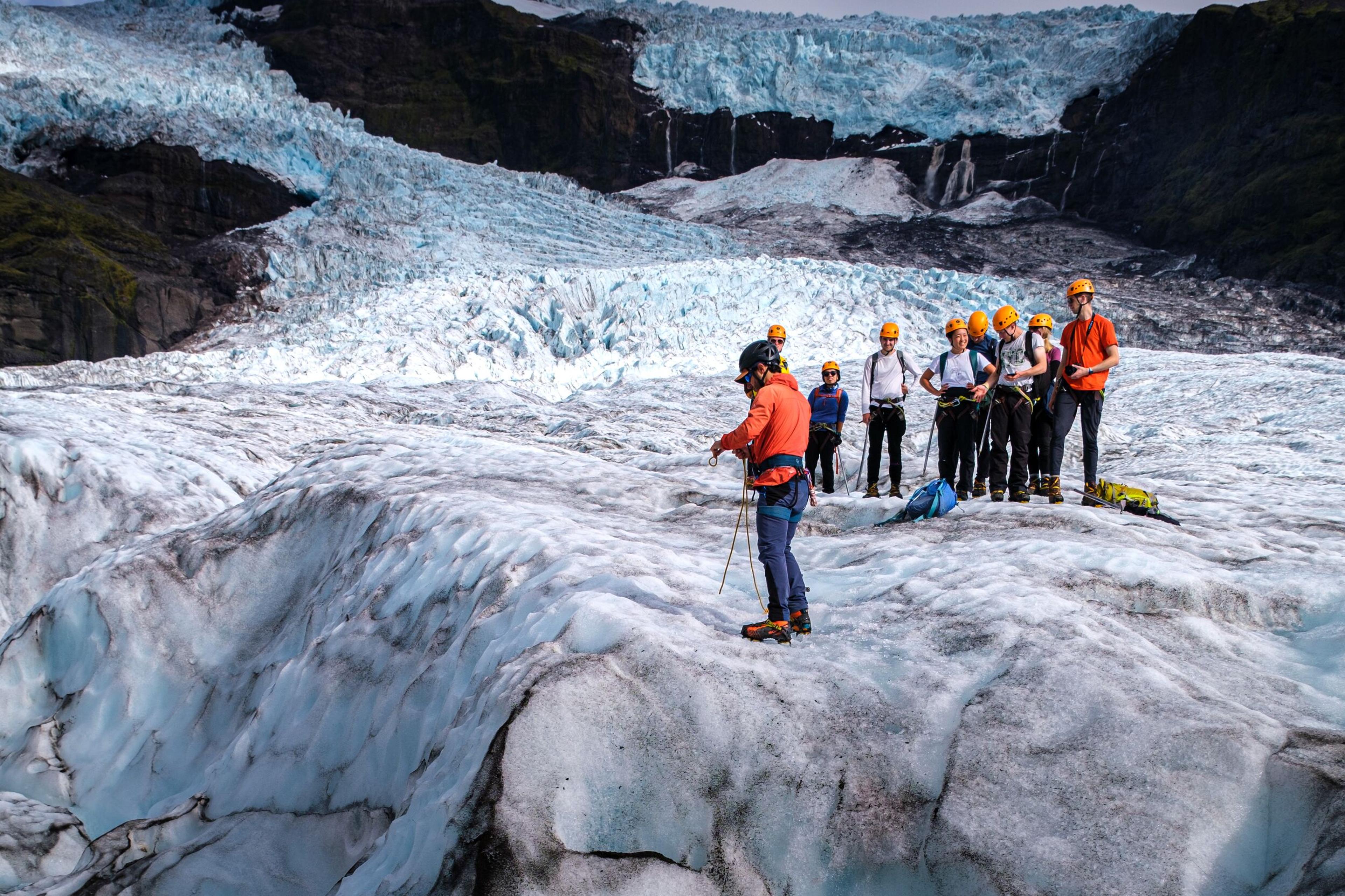 A guide on the Skaftafell Glacier explaining the geology of it to a group of tourists