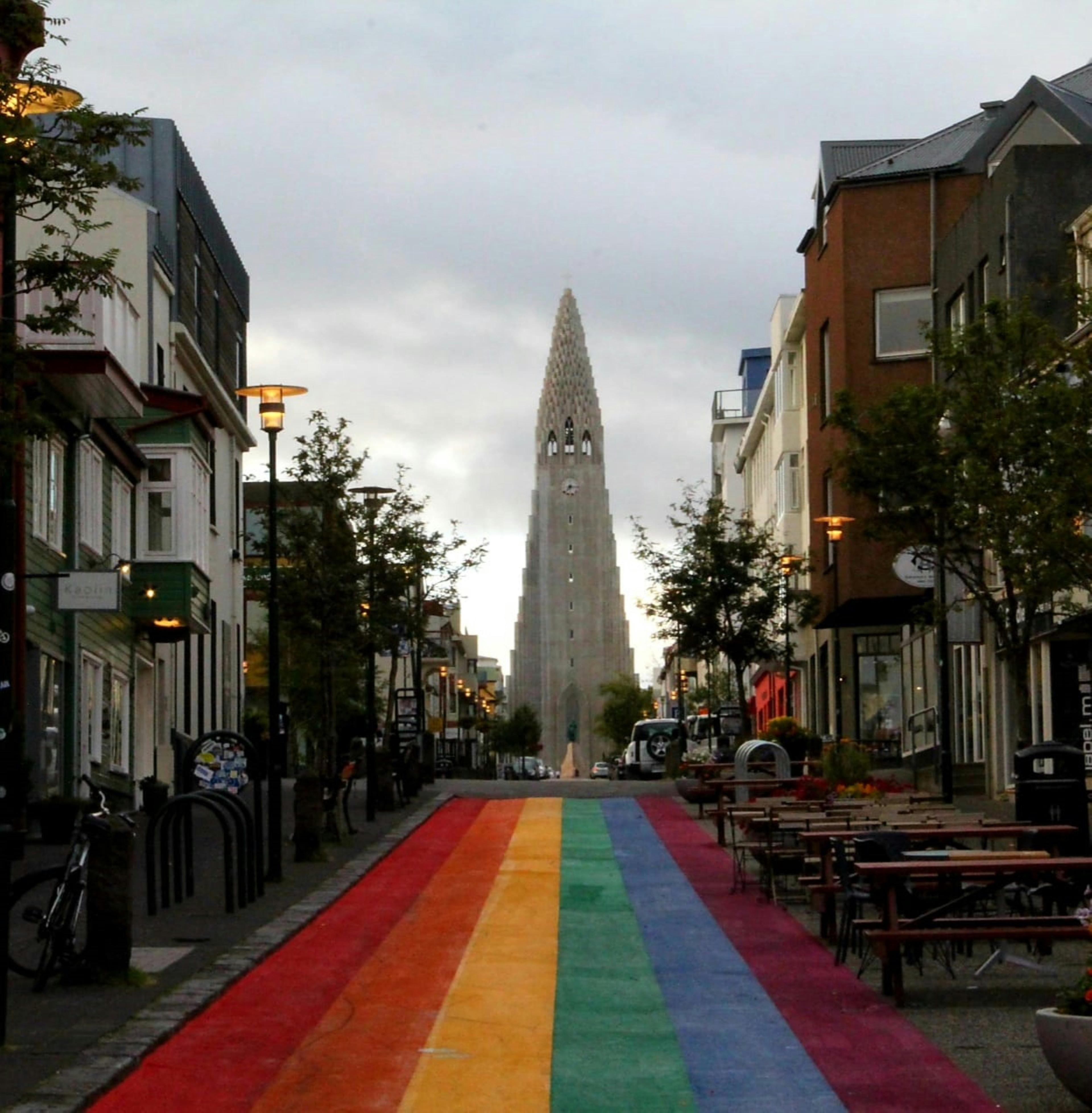 Reykjavik street with rainbow pavement leading to Hallgrimskirkja church, celebrating Reykjavik Pride.