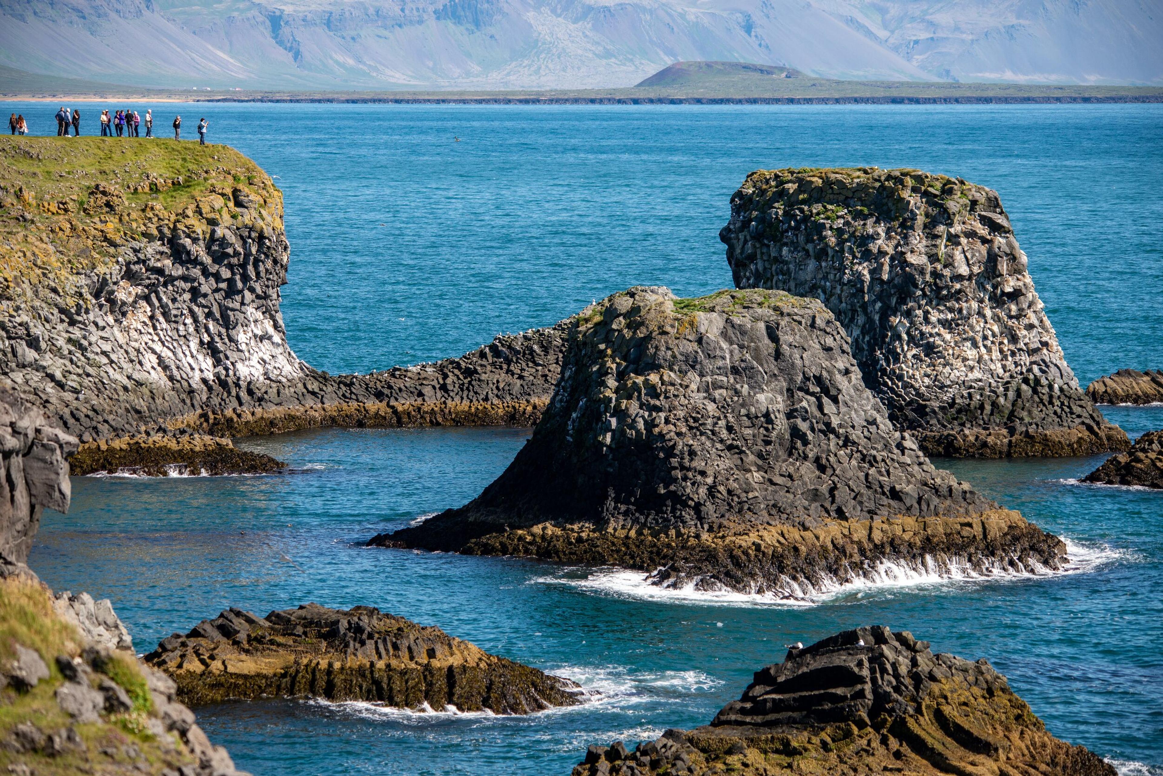 "Stunning coastal rock formations sculpted by nature's forces.