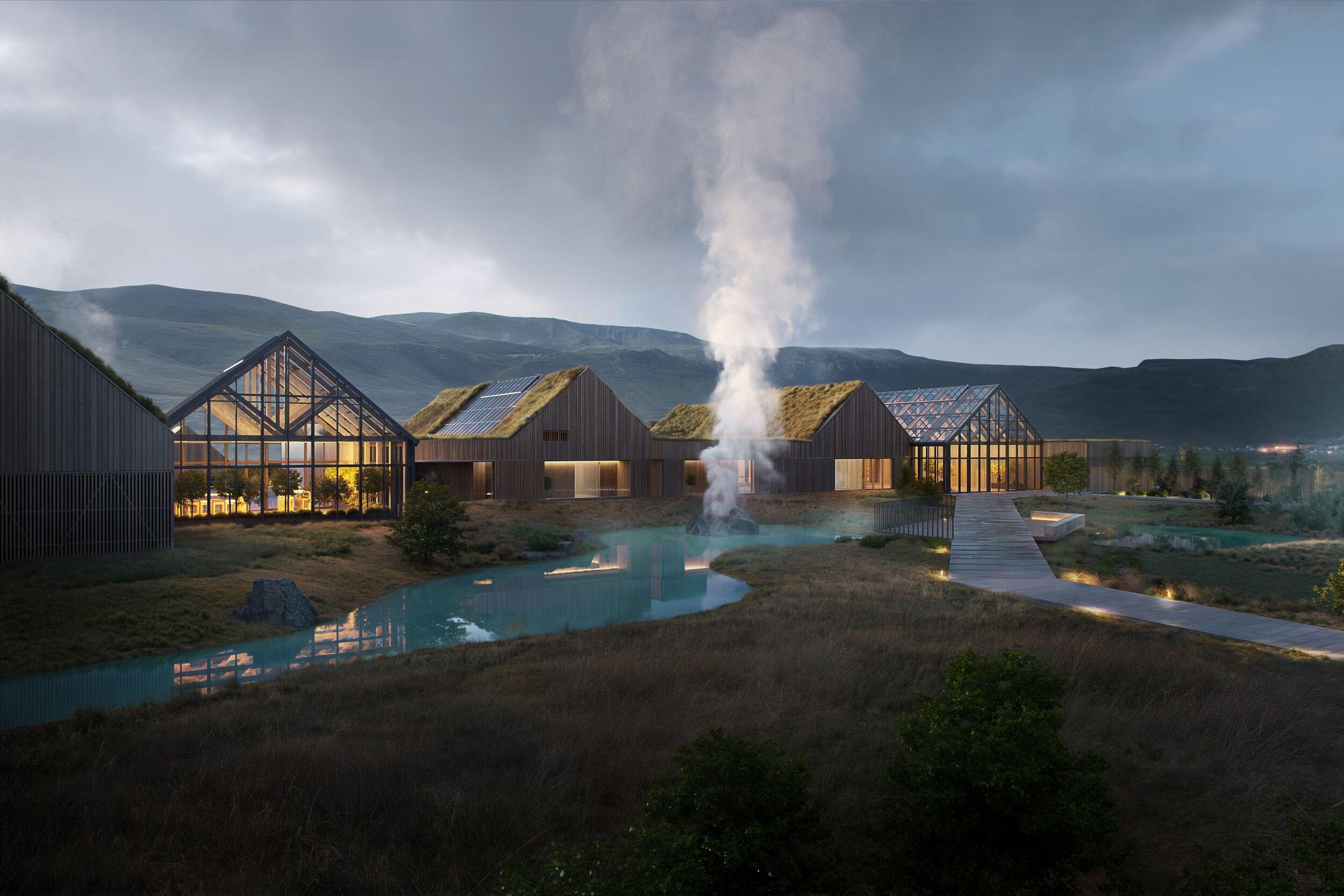 Modern buildings with grass roofs and glass facades line a turquoise stream with steam rising, set against a mountainous landscape at dusk.