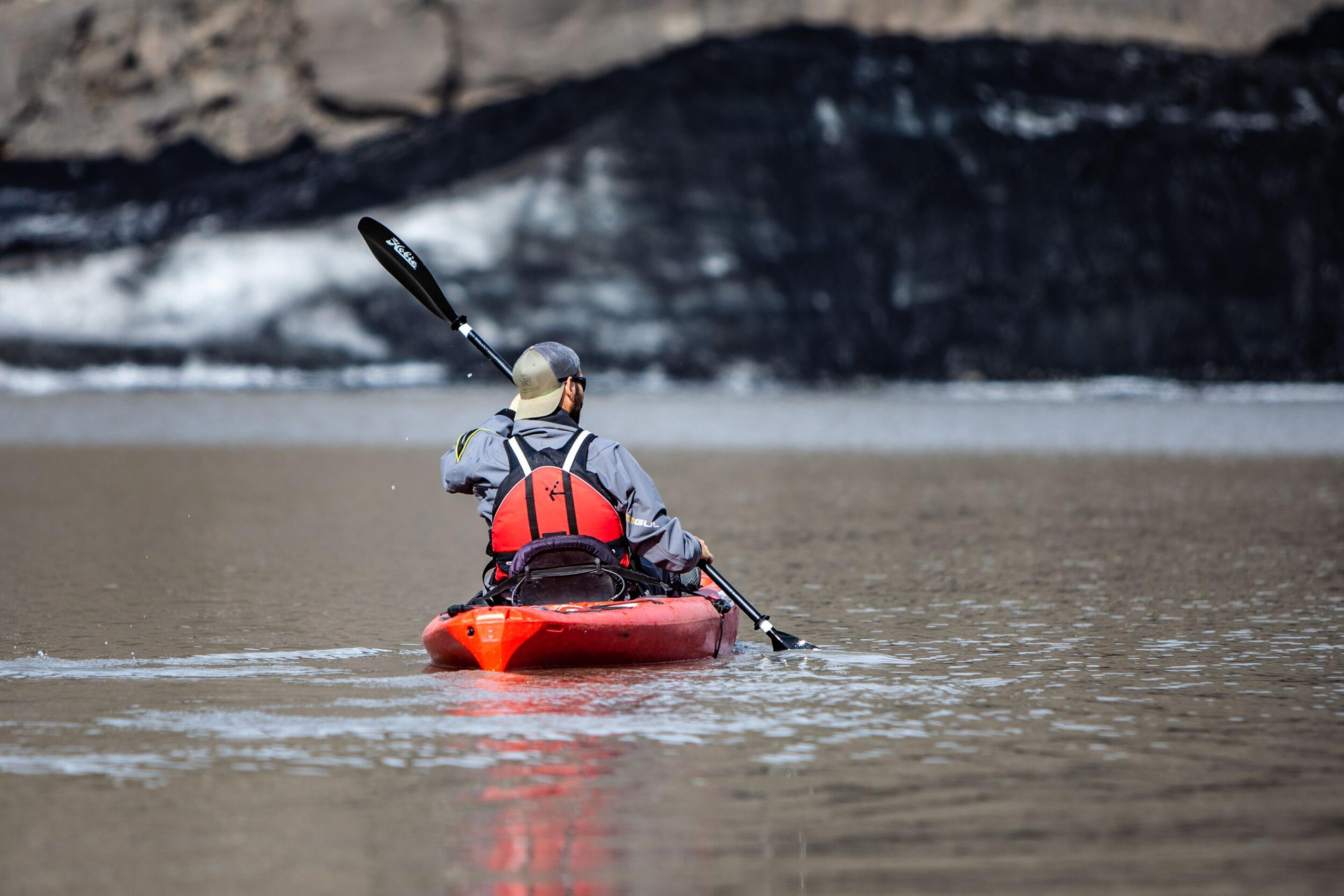 A person on a kayak in the glacier lagoon on the south coast of Iceland.