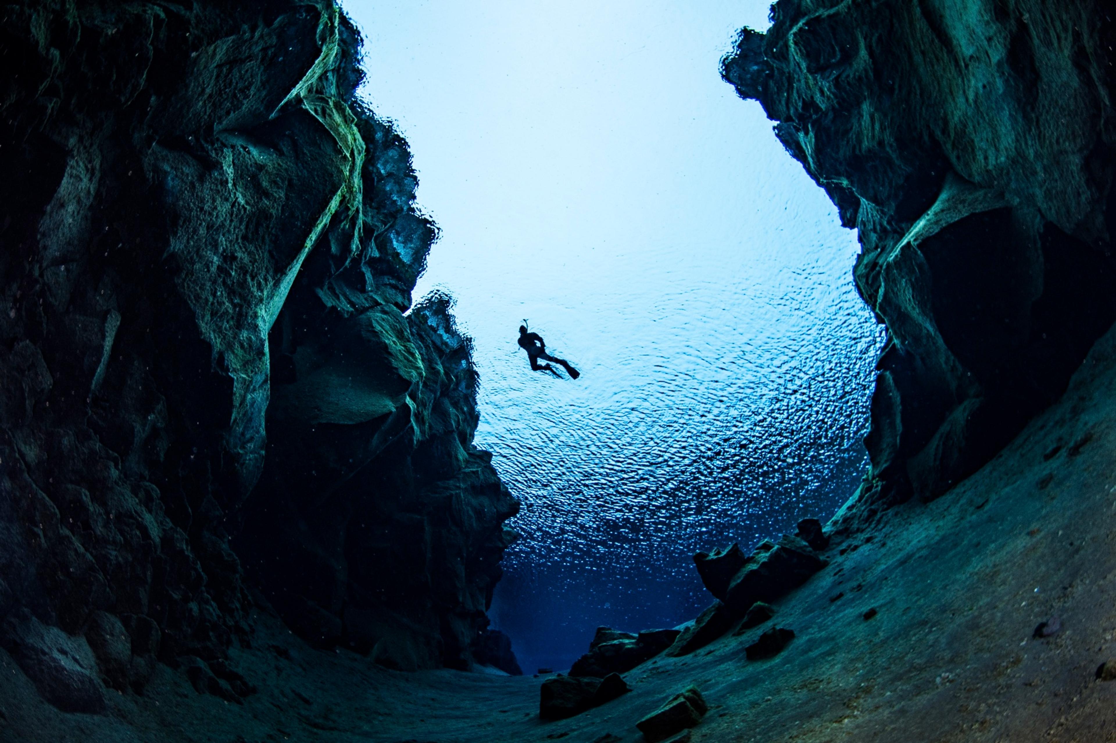 A photo of Silfra fissure. Snorkeler in the background.