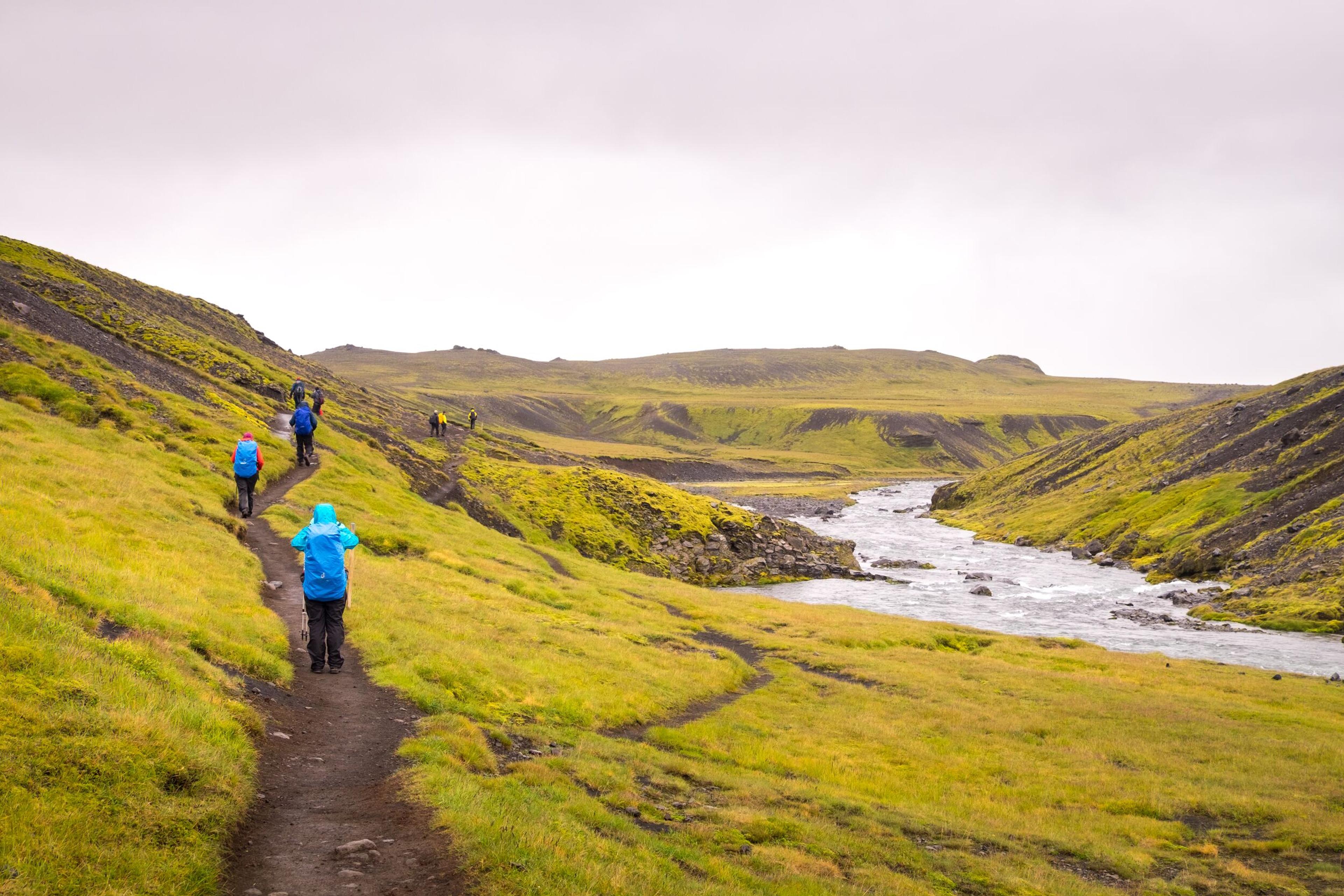 Tourists walking on a hiking path in Fimmvörðuháls area, south coast Iceland.