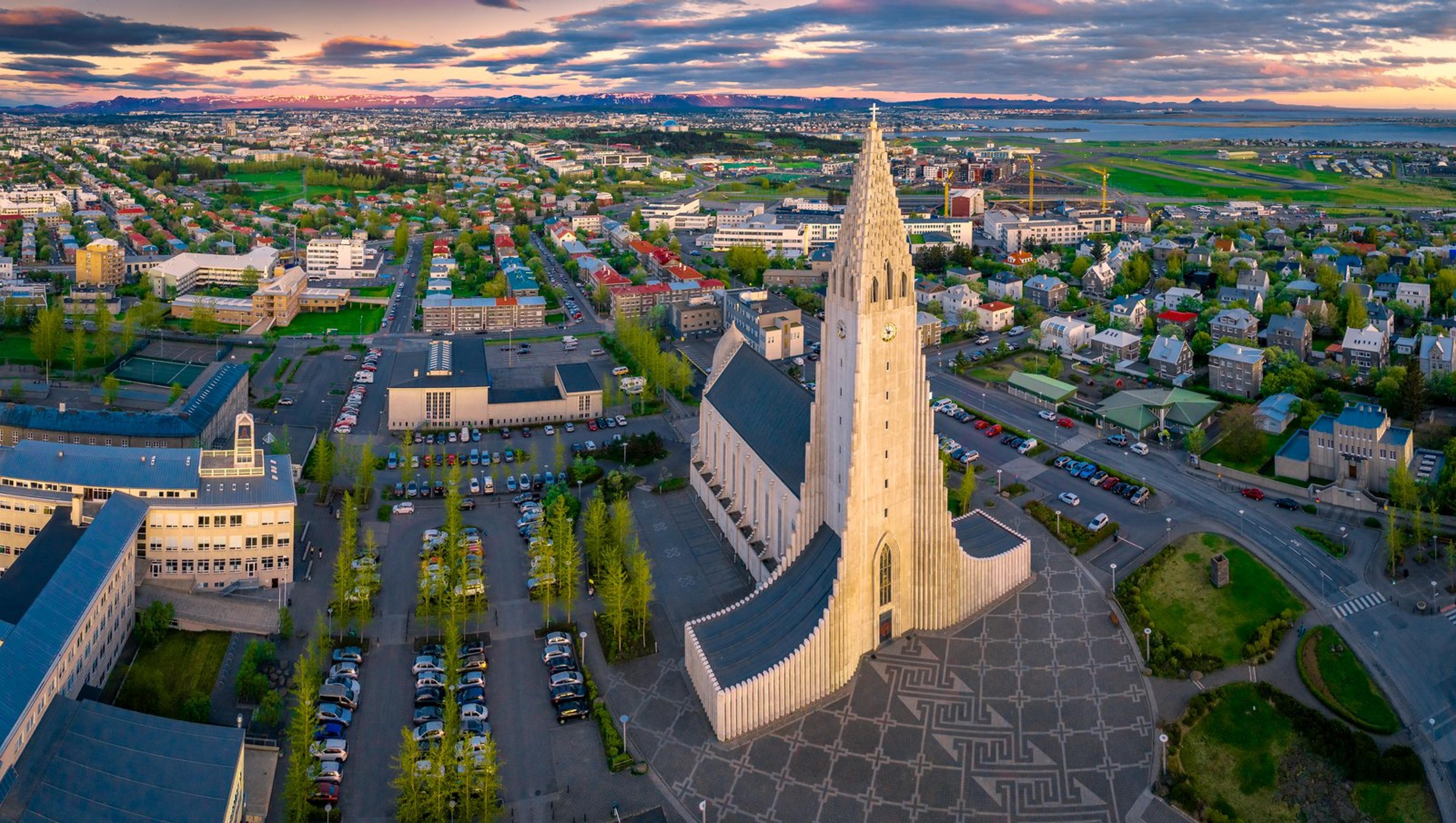 Aerial view of Hallgrímskirkja church towering over Reykjavik, Iceland, at sunset.