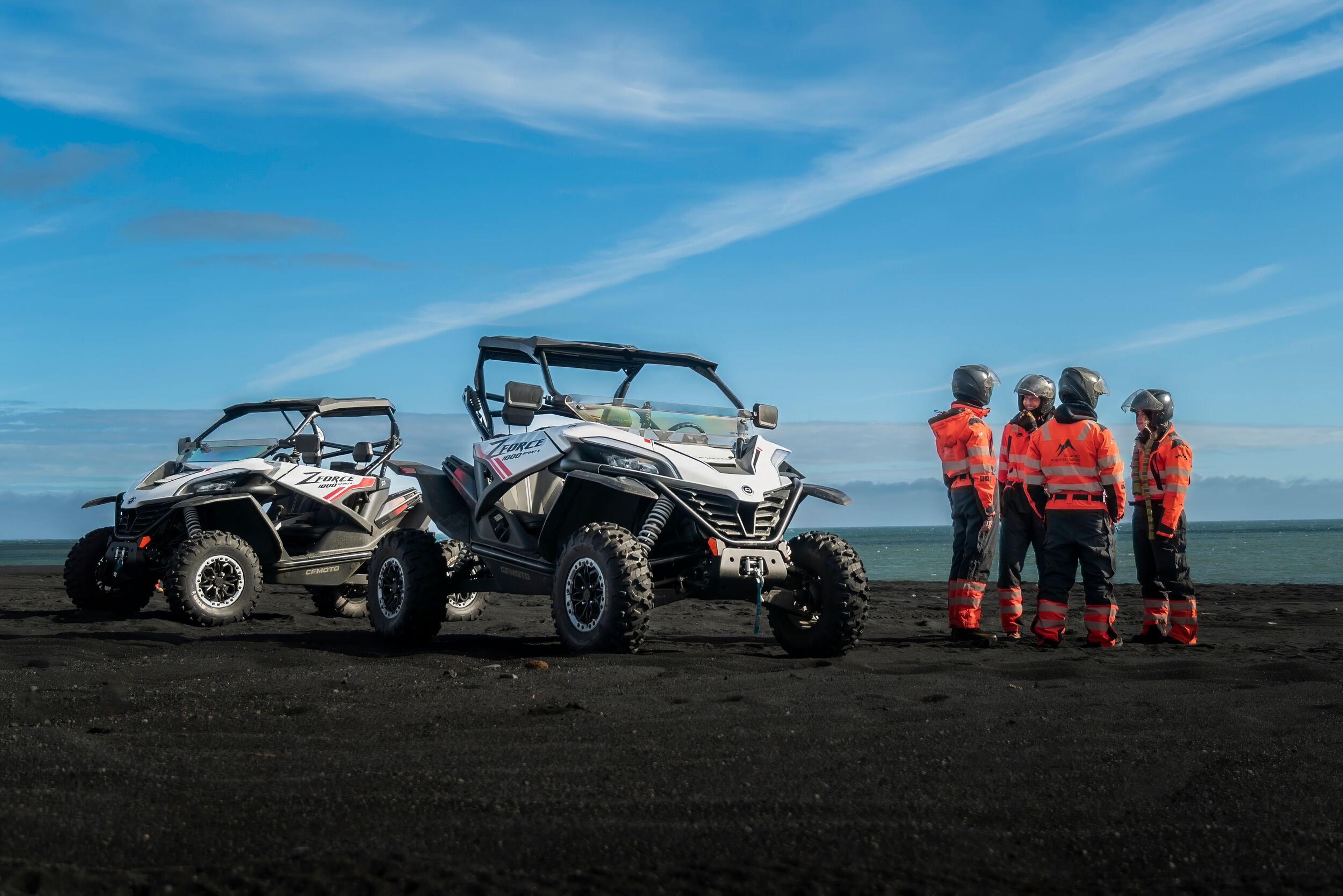 group of people beside two buggies on the icelandic black beach