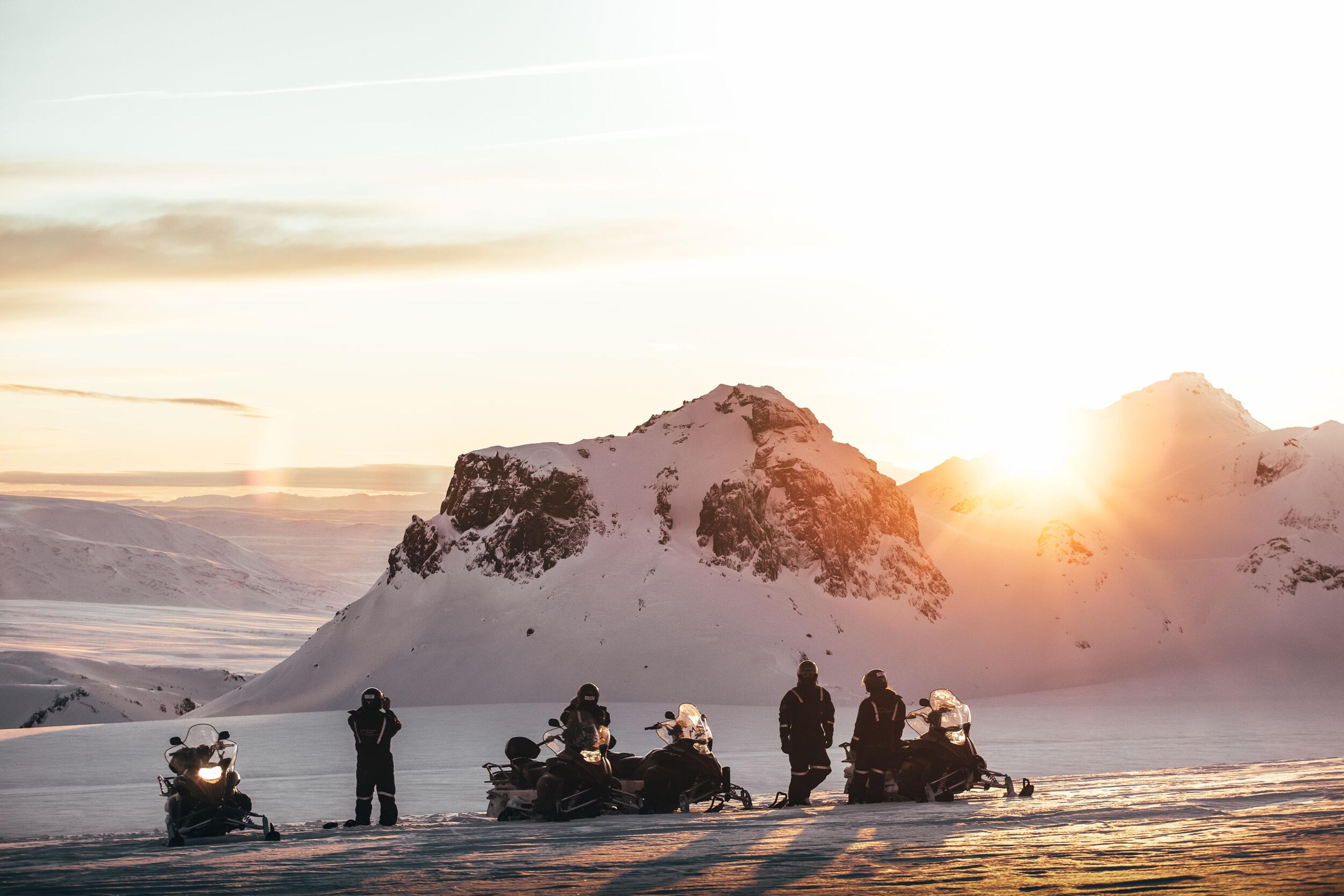 Tourists on snowmobiles taking pictures in Langjökull glacier, Iceland.