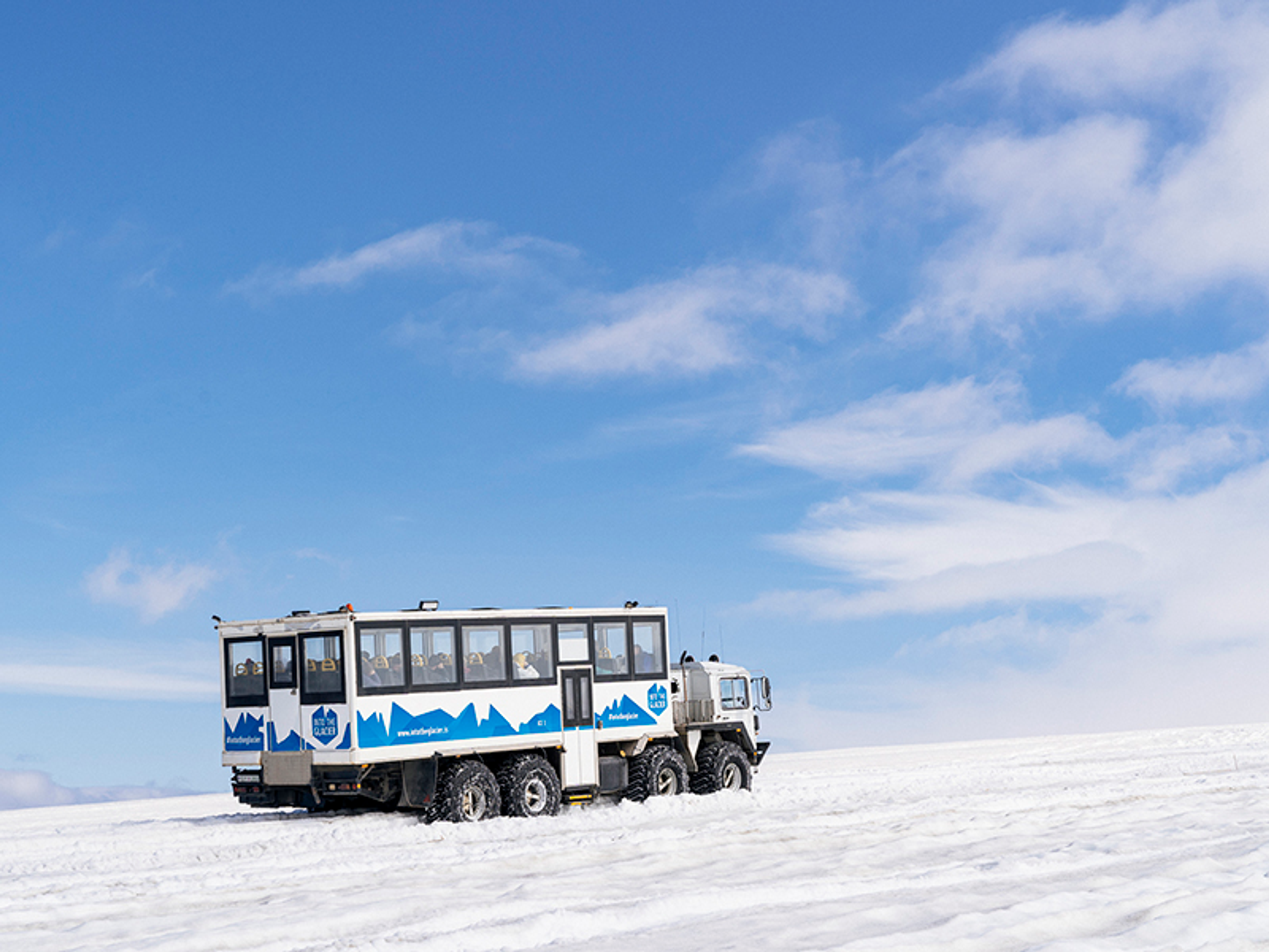 Monster truck driving on Langjökull glacier.