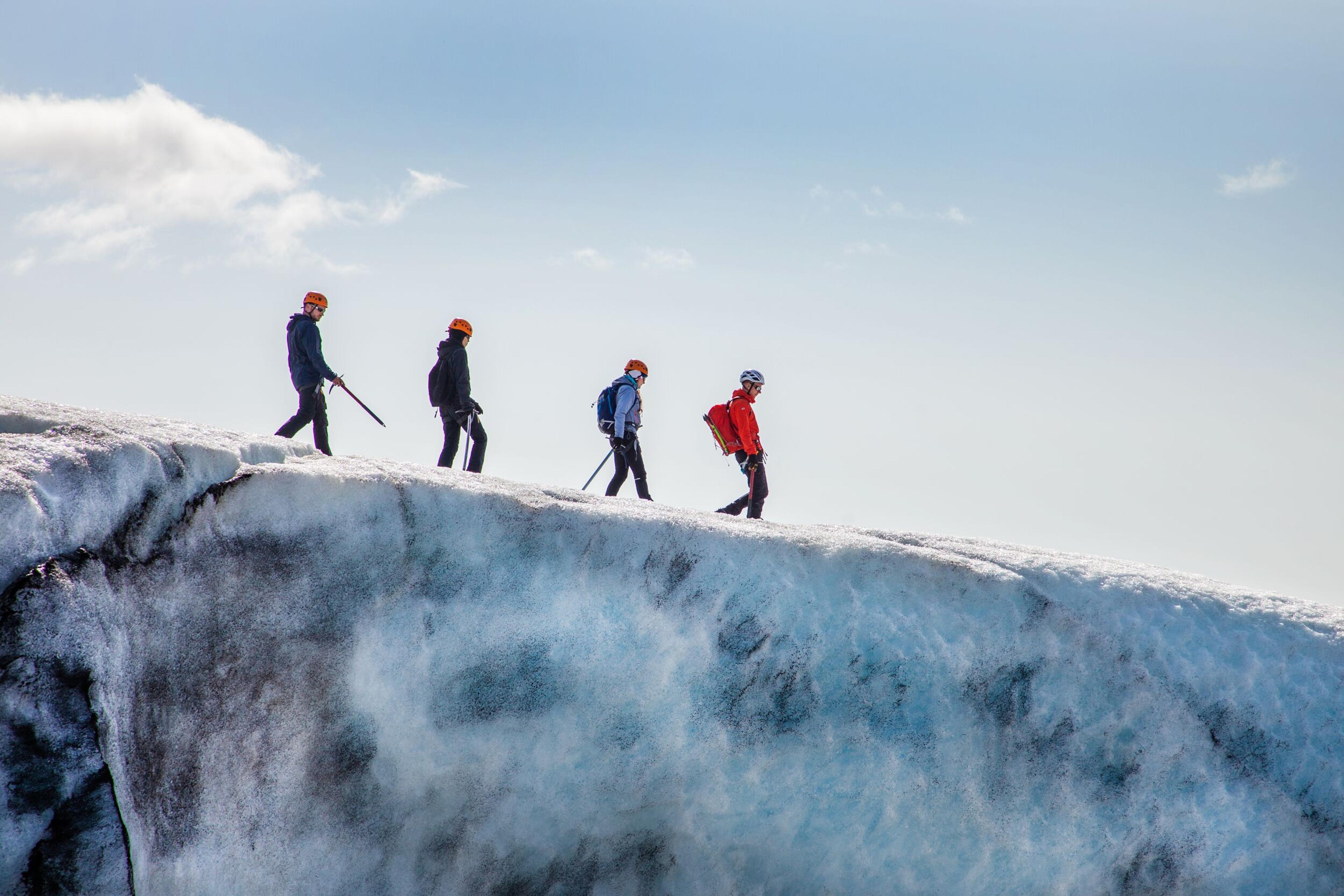 Hikers walking on the Sólheimajökull glacier in the south coast of Iceland.