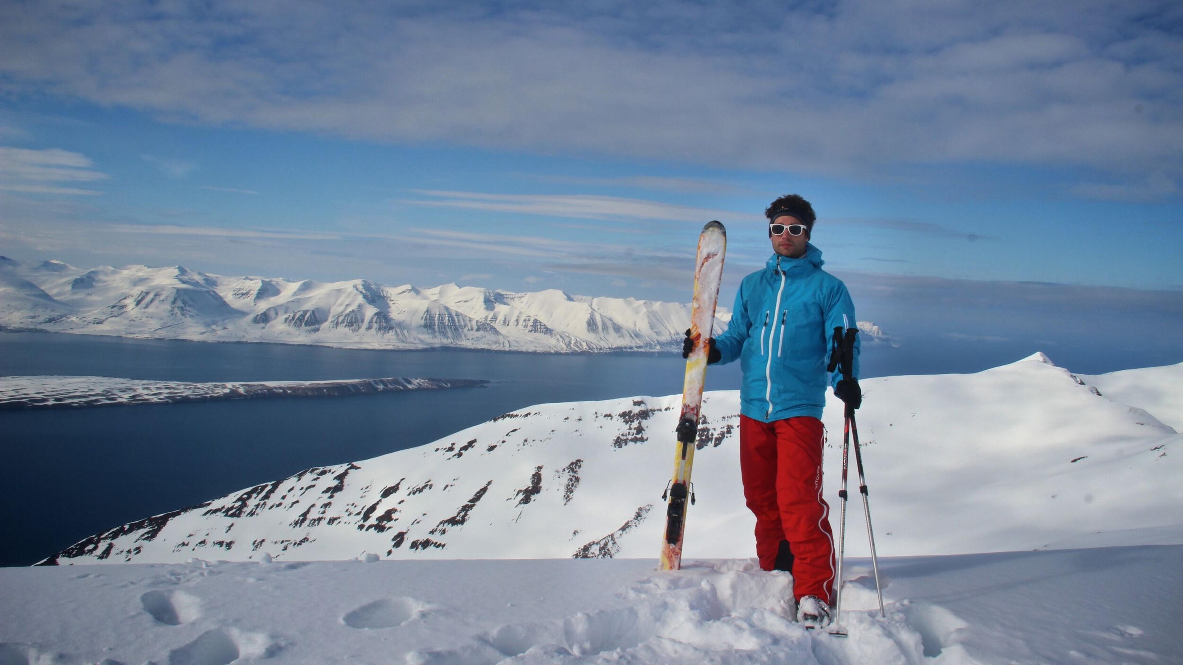 Skier on top of mountain Kaldbakur,  view over Eyjafjörður and Hrísey island