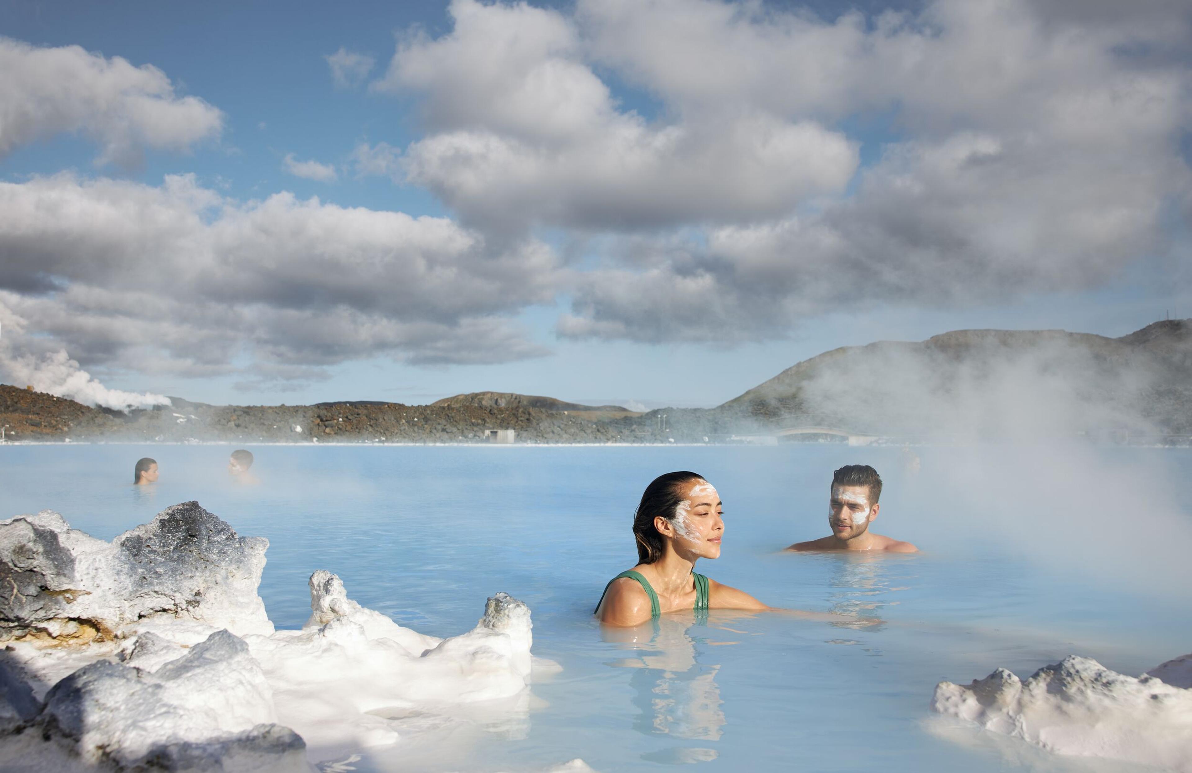 People at the Blue Lagoon, silica covered rocks in foreground