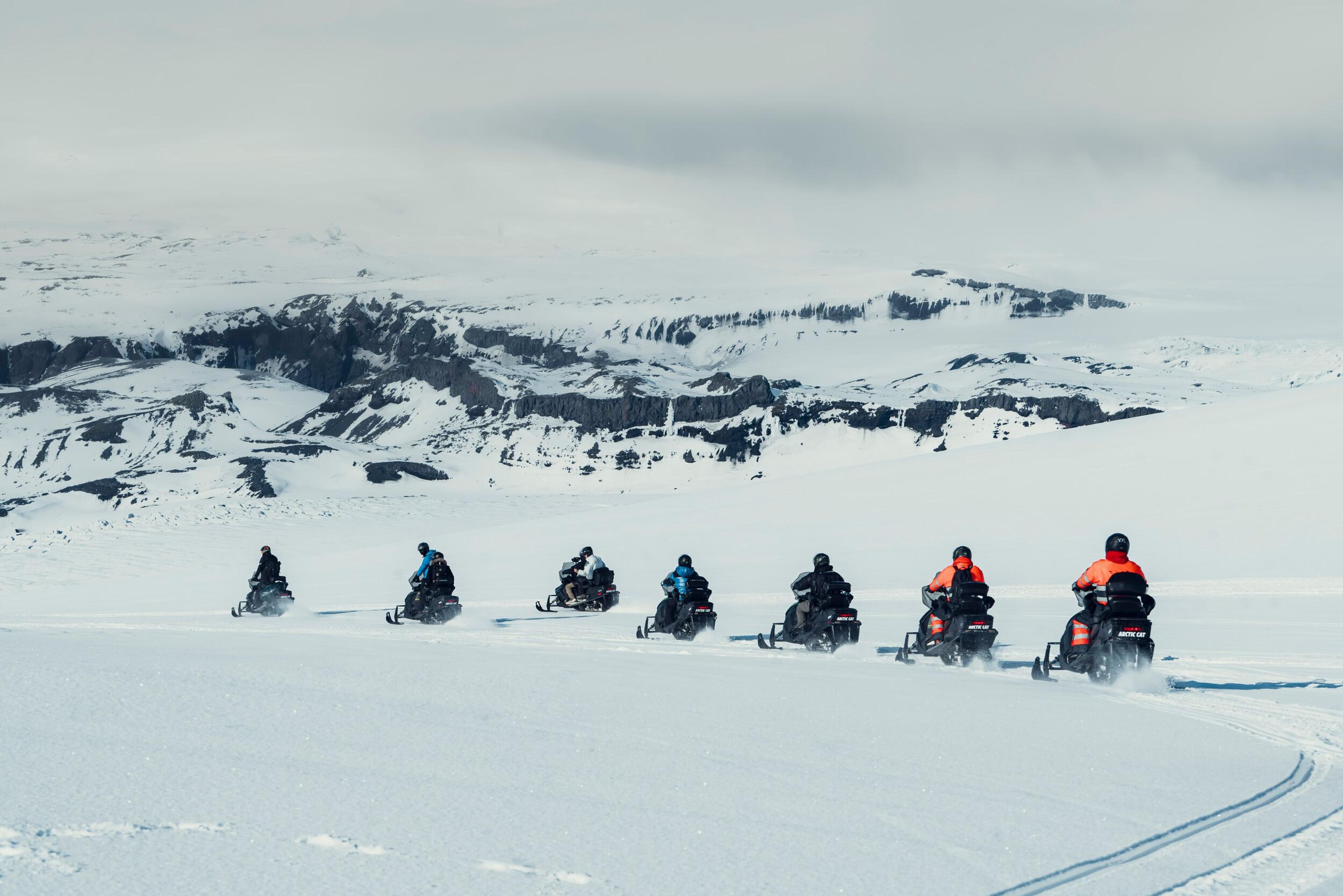 Snowmobiles riding on Mýrdalsjökull glacier in the south coast of Iceland.