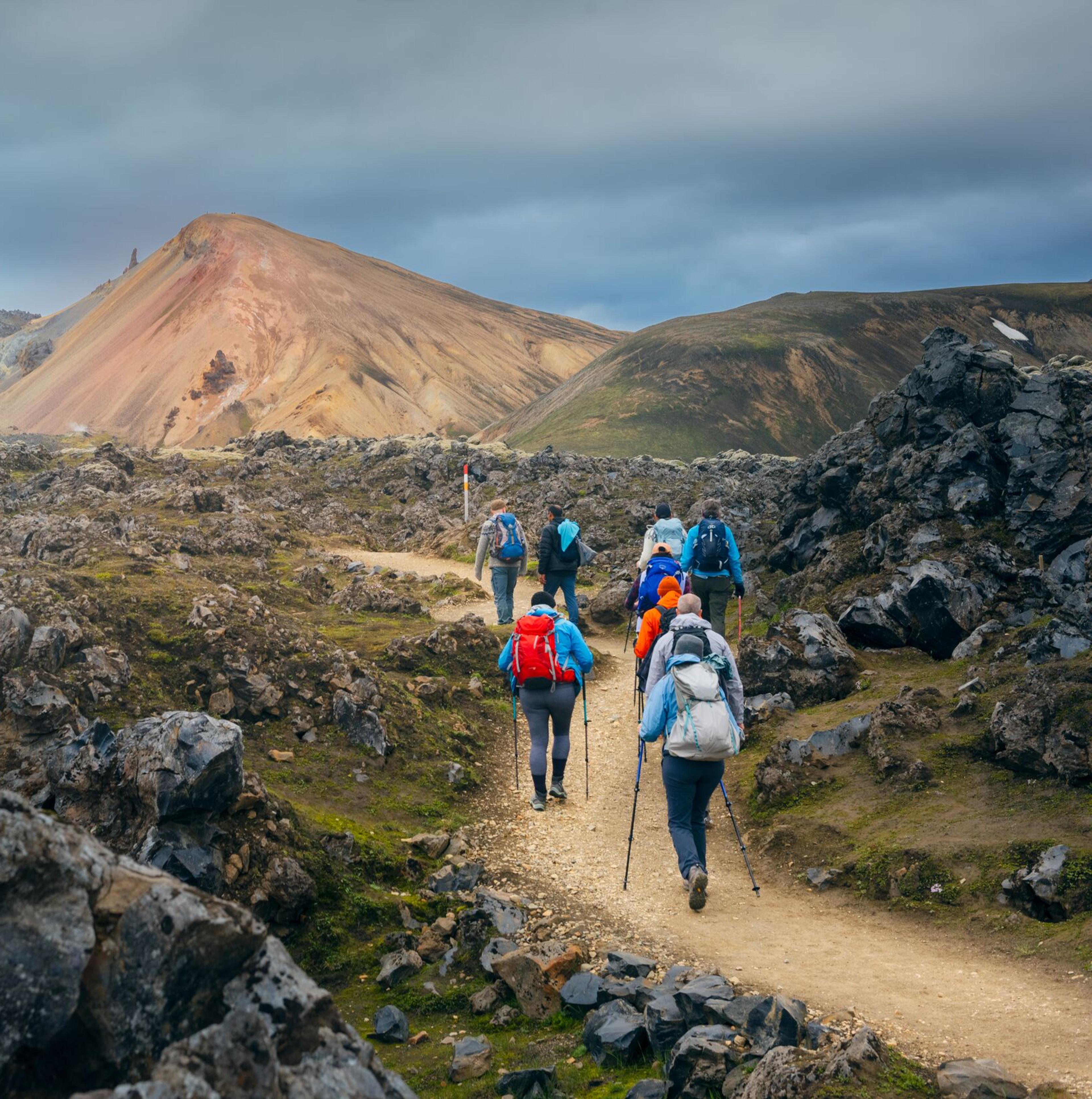 Group of explorers hiking through Landmannlaugar area.