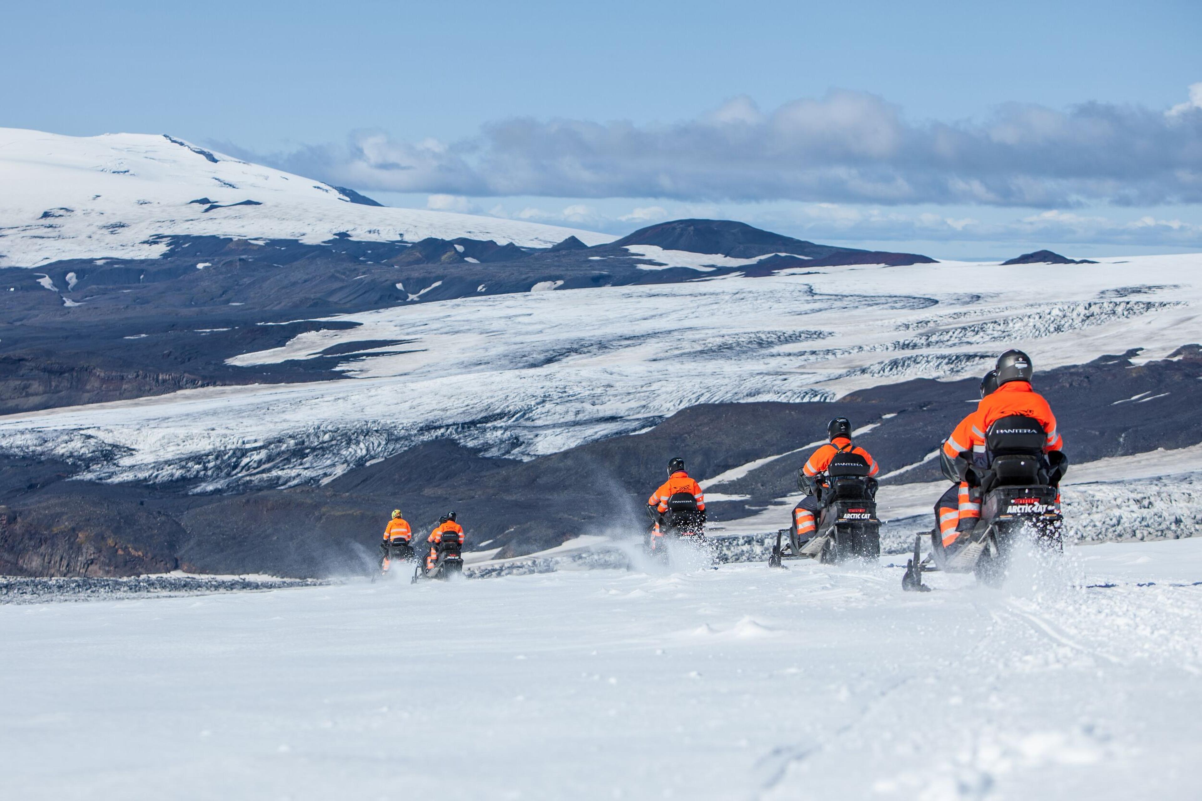 Tourists on snowmobiles at Myrdalsjökull Glacier in the south coast of Iceland.