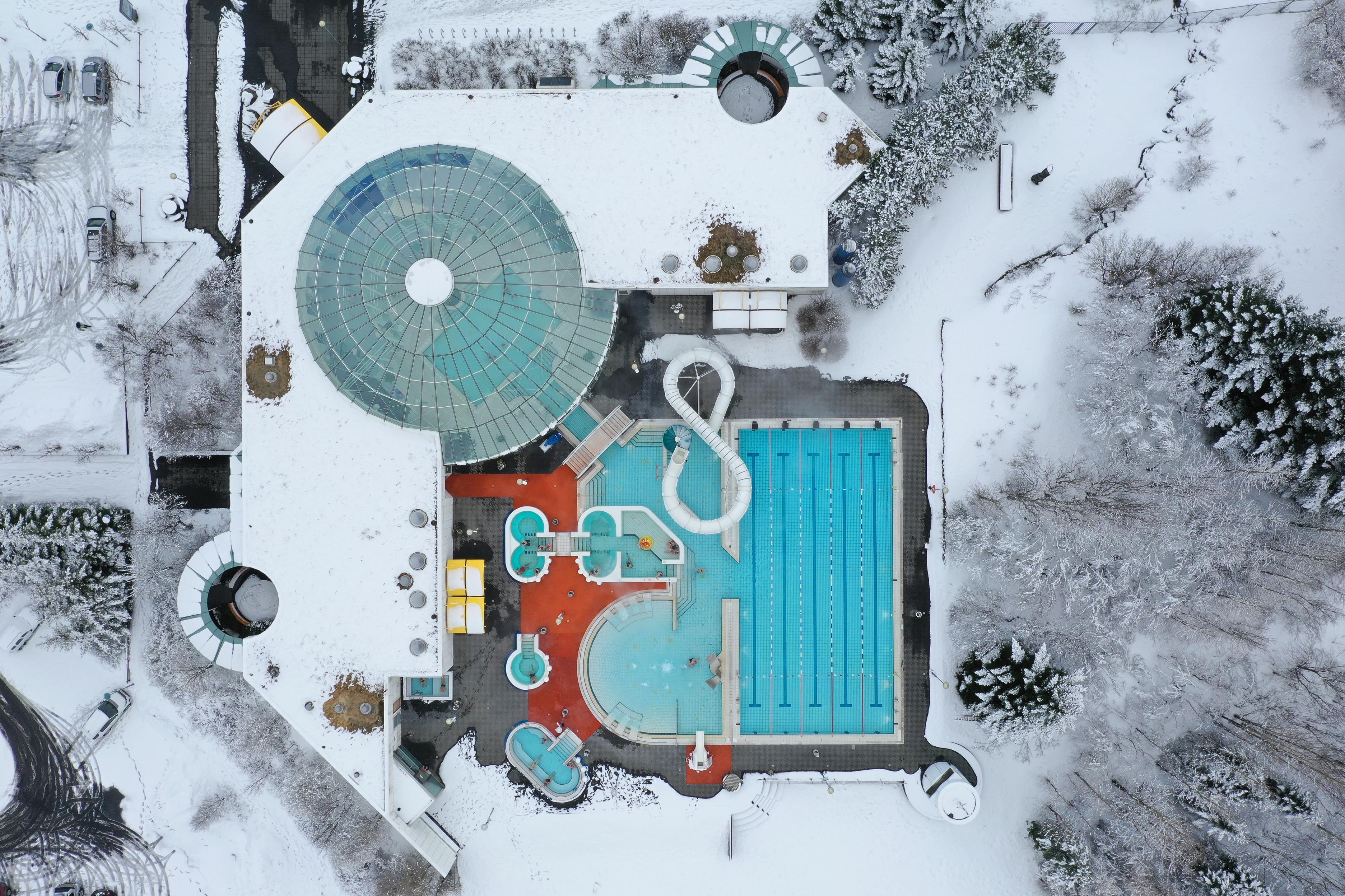 Aerial perspective of a bustling public geothermal pool in Reykjavík