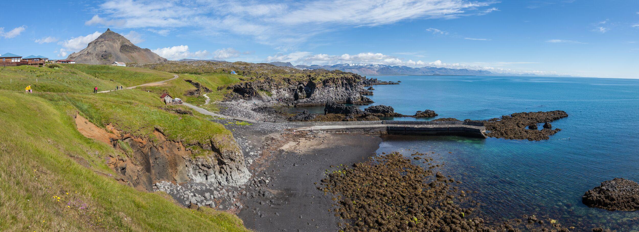 Green Grass on the Left, Small Beach in the Middle, and Ocean on the Right, Featuring an Old Port and a Cozy Café Hu