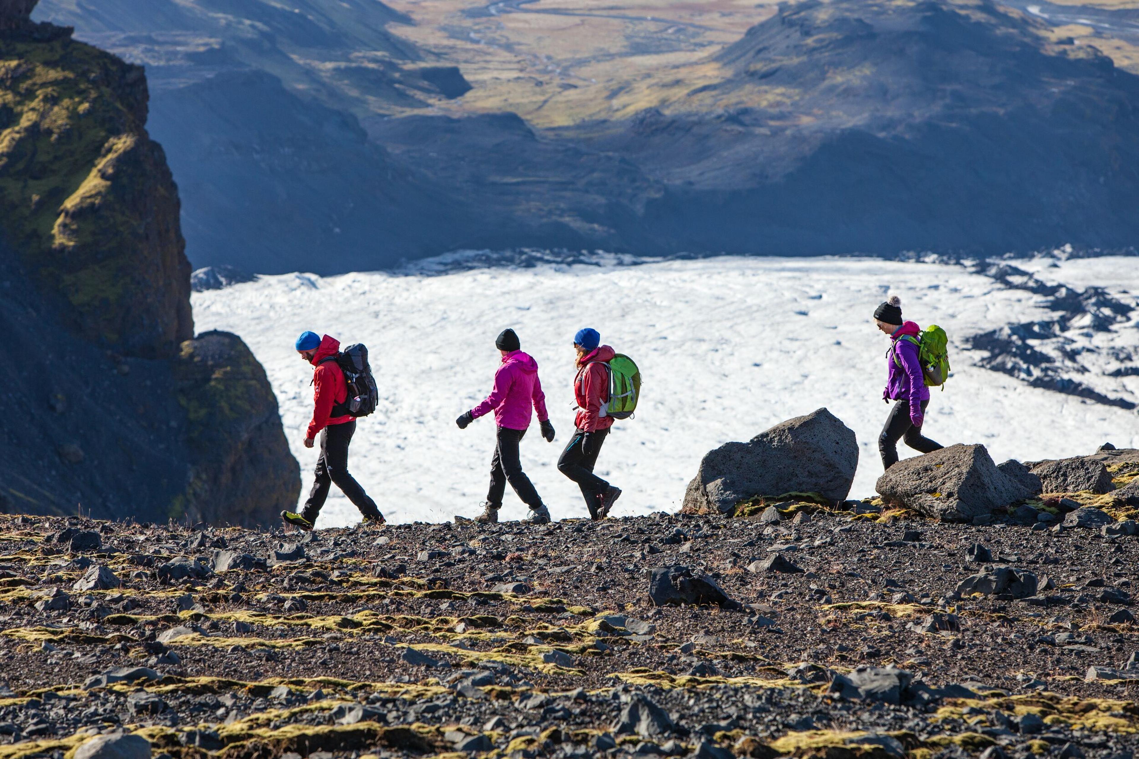 Hikers on a mountain path near the Sólheimajökull Glacier in the south coast of Iceland.