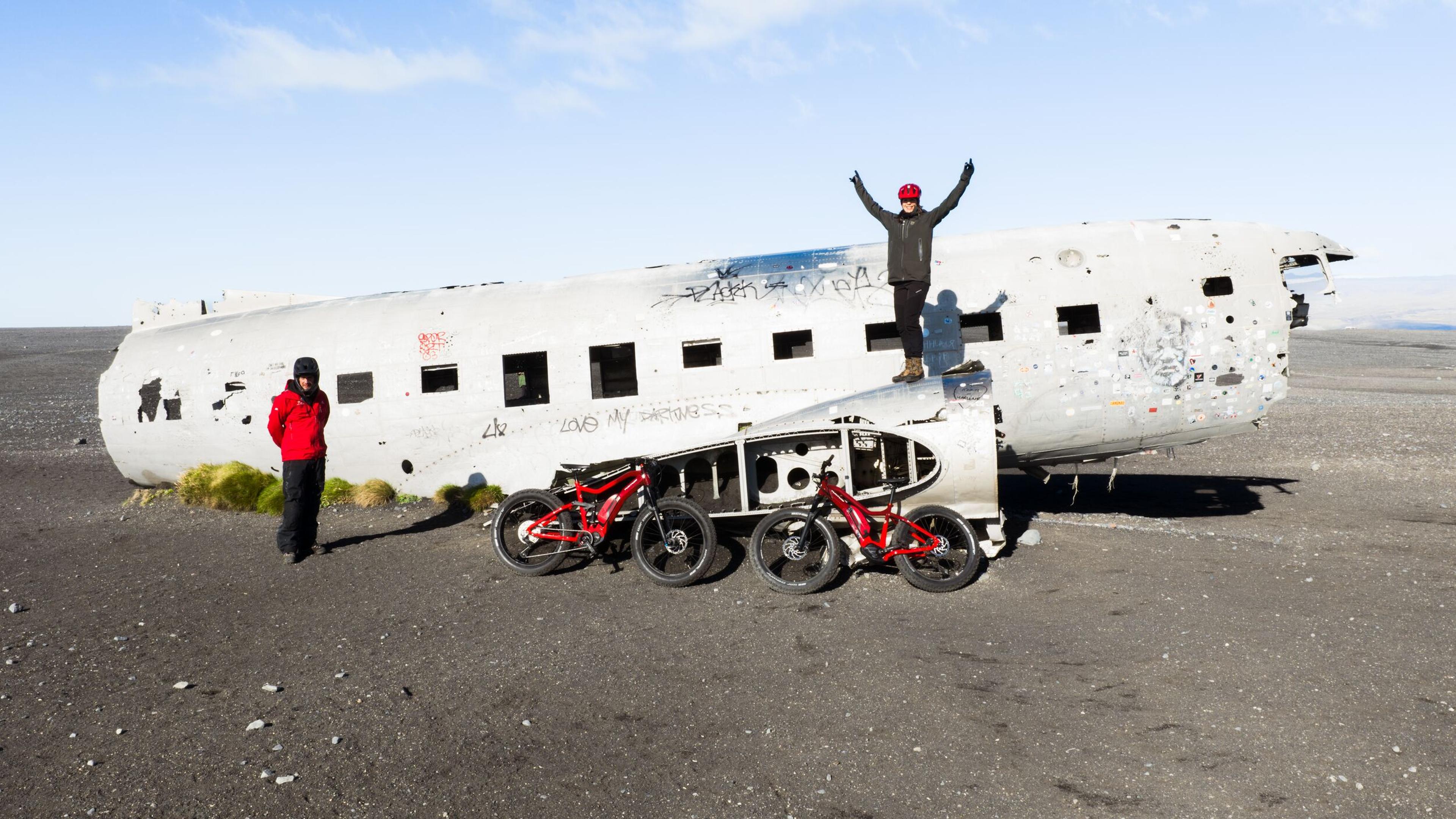 a man is standing on the side of an airplane .