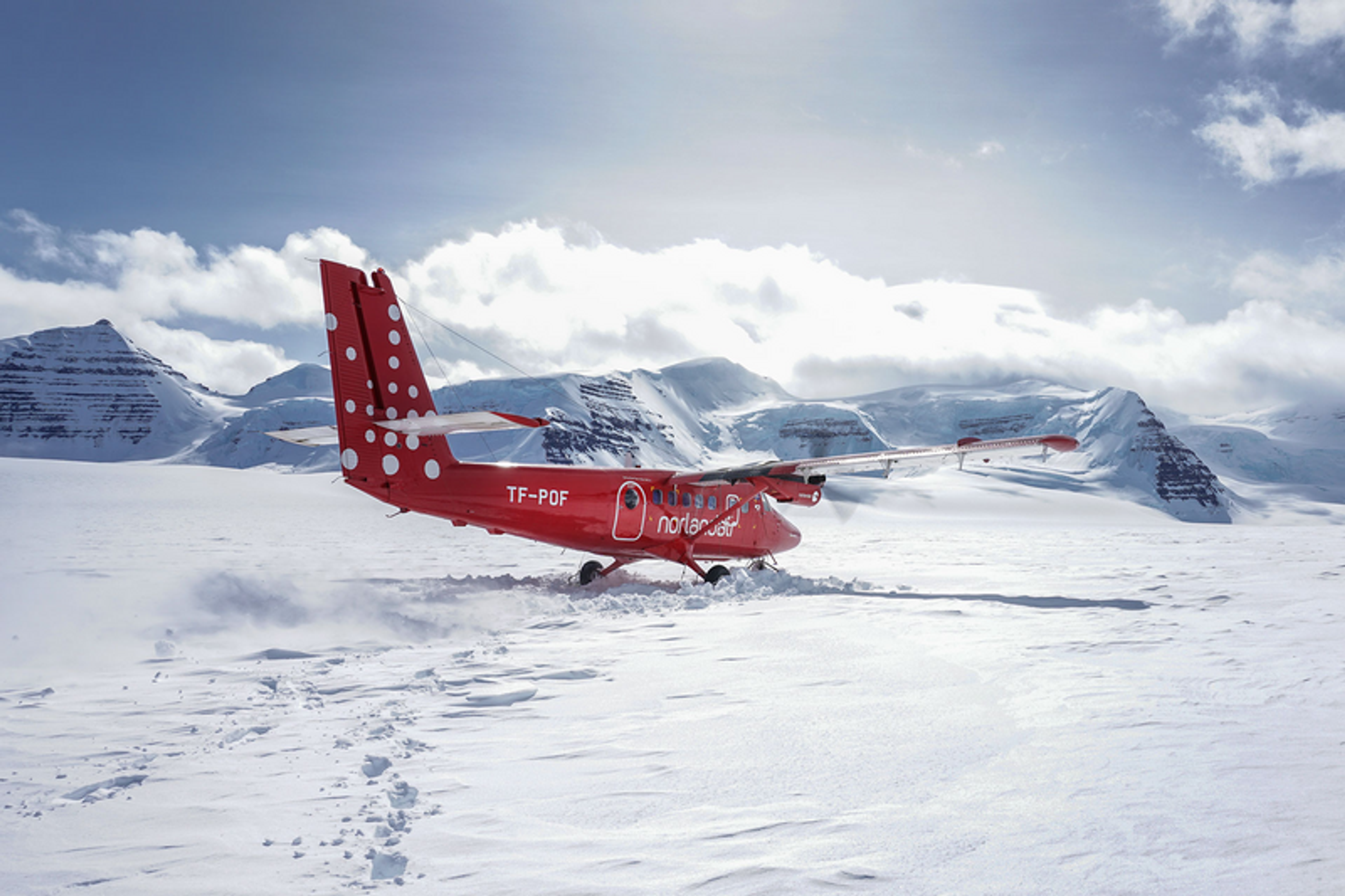 Airplane landing at the base of Mount Gunnbjörn in Greenland