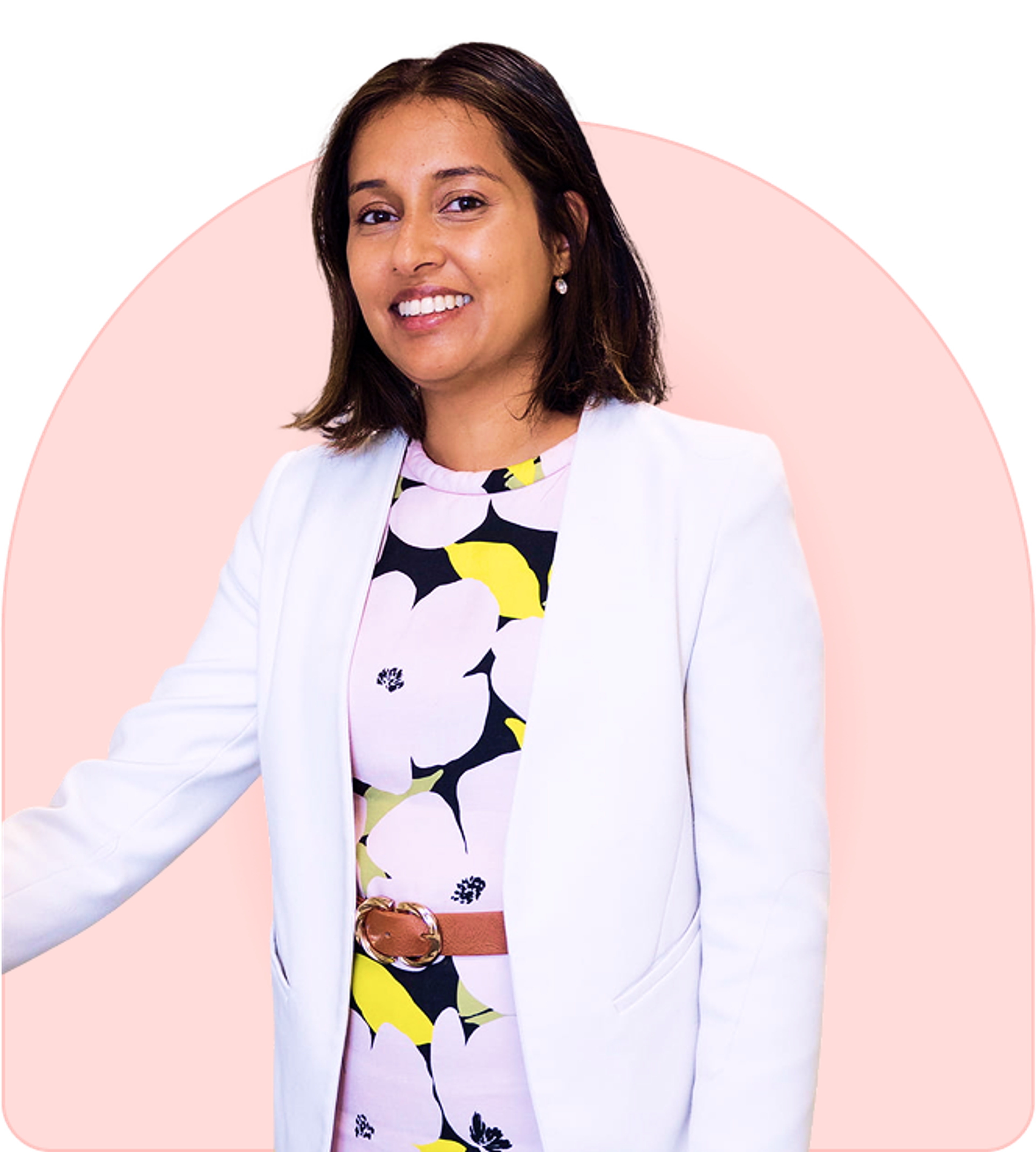 Smiling pelvic pain specialist in a white blazer, exuding warmth and confidence.