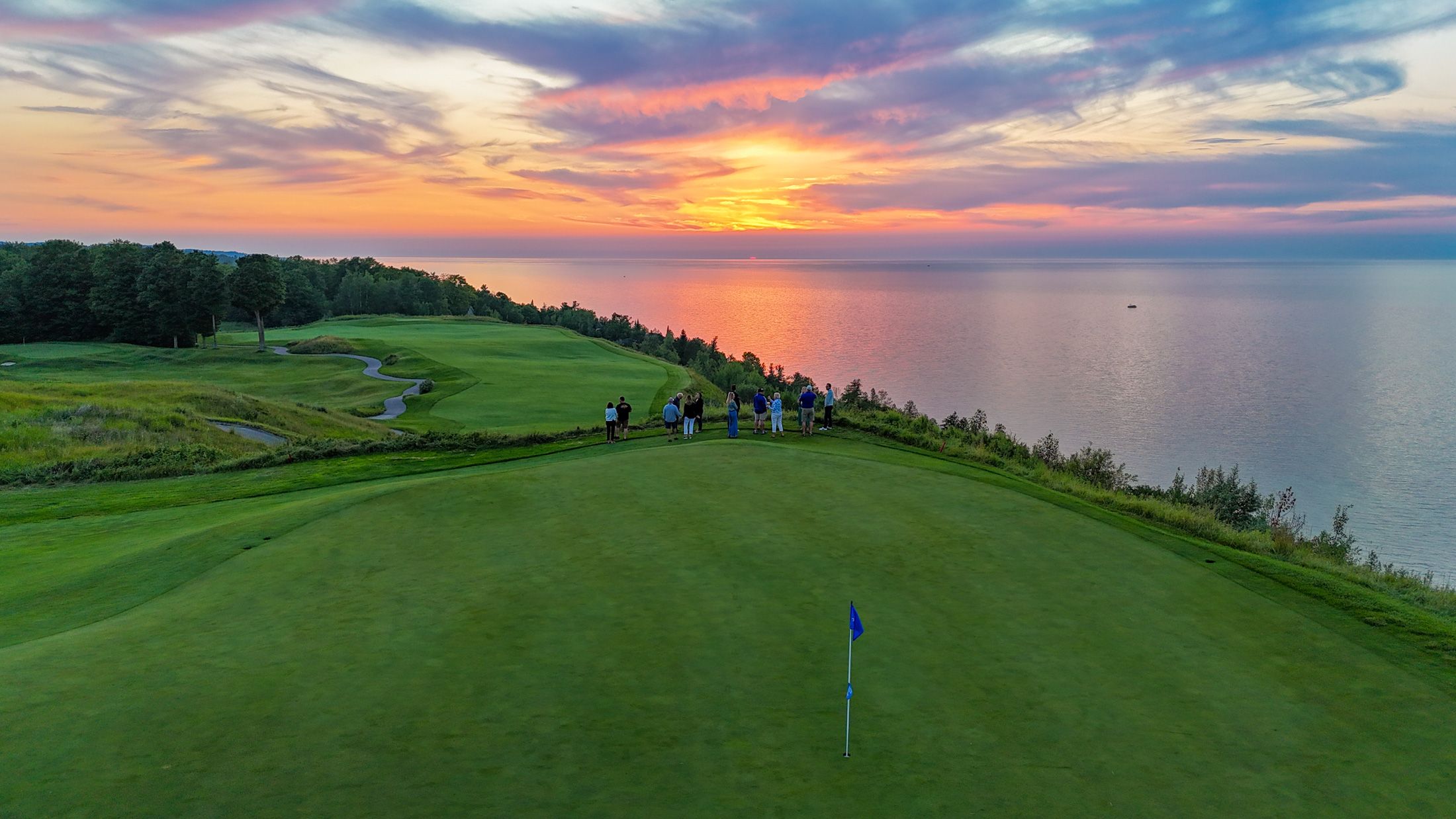 Guests take in a stunning sunset on the final stop of the Cliffview Cart Cruise