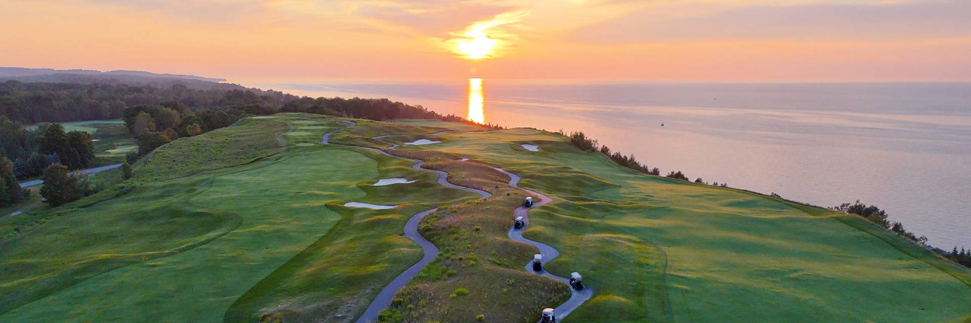 Cliffview Cart Cruise carts drive into the Lake Michigan sunset