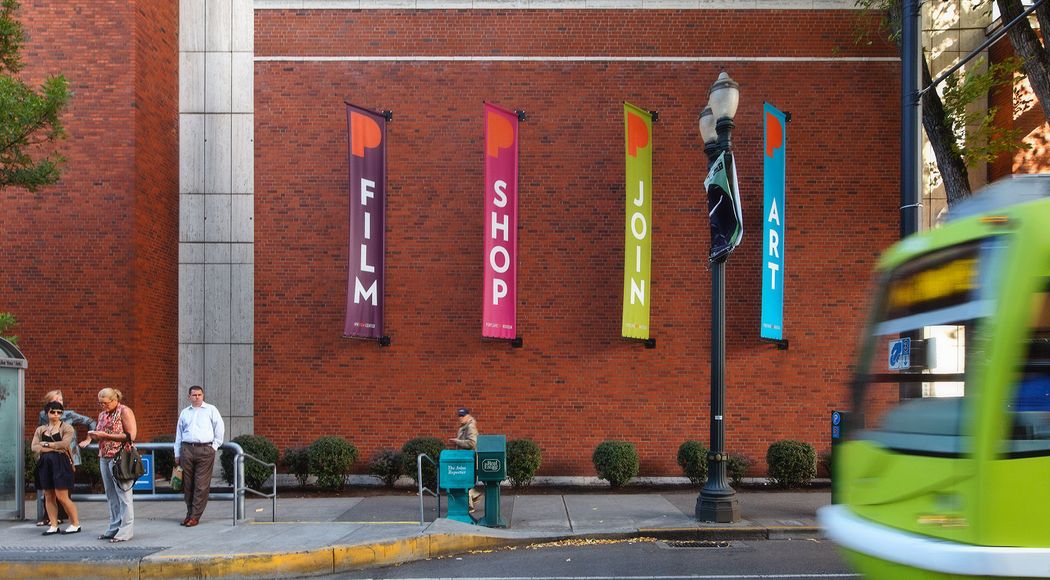 Four Portland Art Museum banners next to a bus stop that read “Film”, “Shop”, “Join”, and “Art”